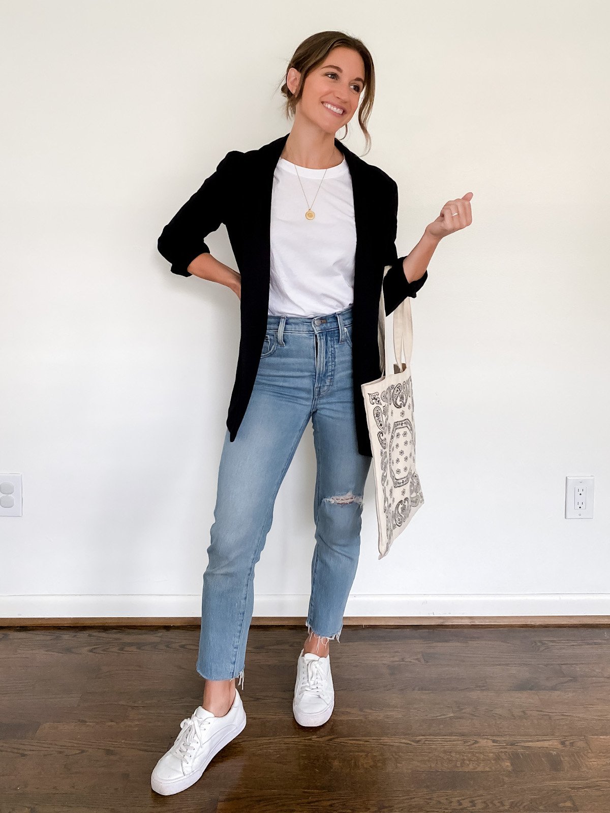 ashley wearing a white tee, black blazer and light wash mom jeans with white sneakers