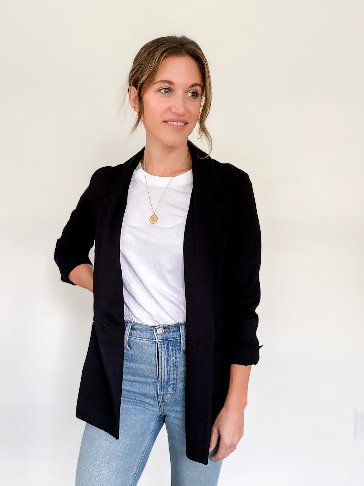 ashley wearing a white tee and black blazer