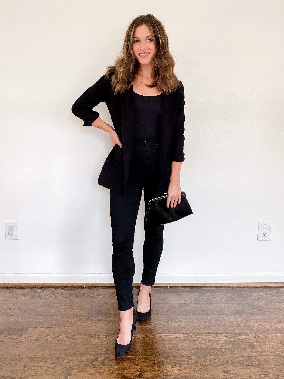 ashley wearing a black bodysuit, black blazer, black skinny jeans and black pumps
