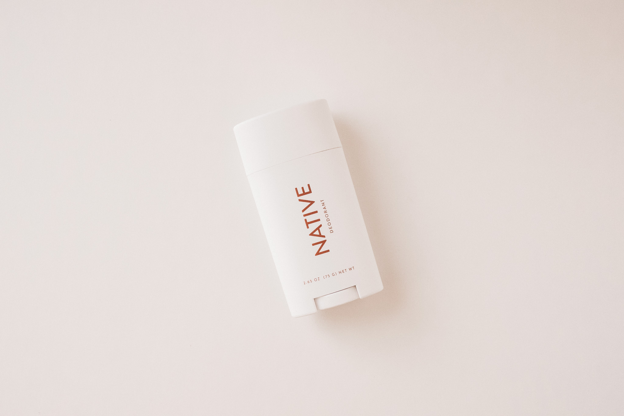 White container of Native Brand deodorant on a white background