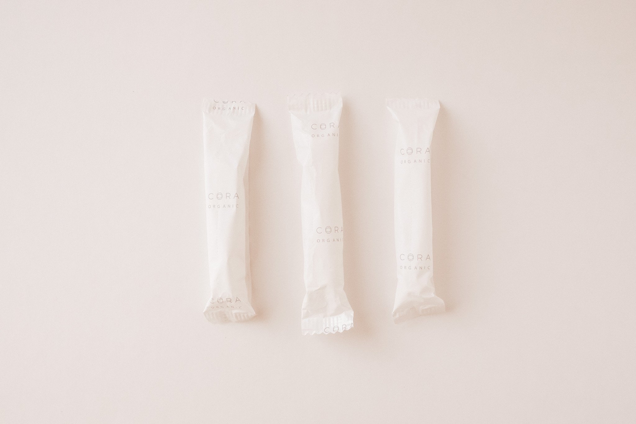 Three white Cora Tampons on a white background 
