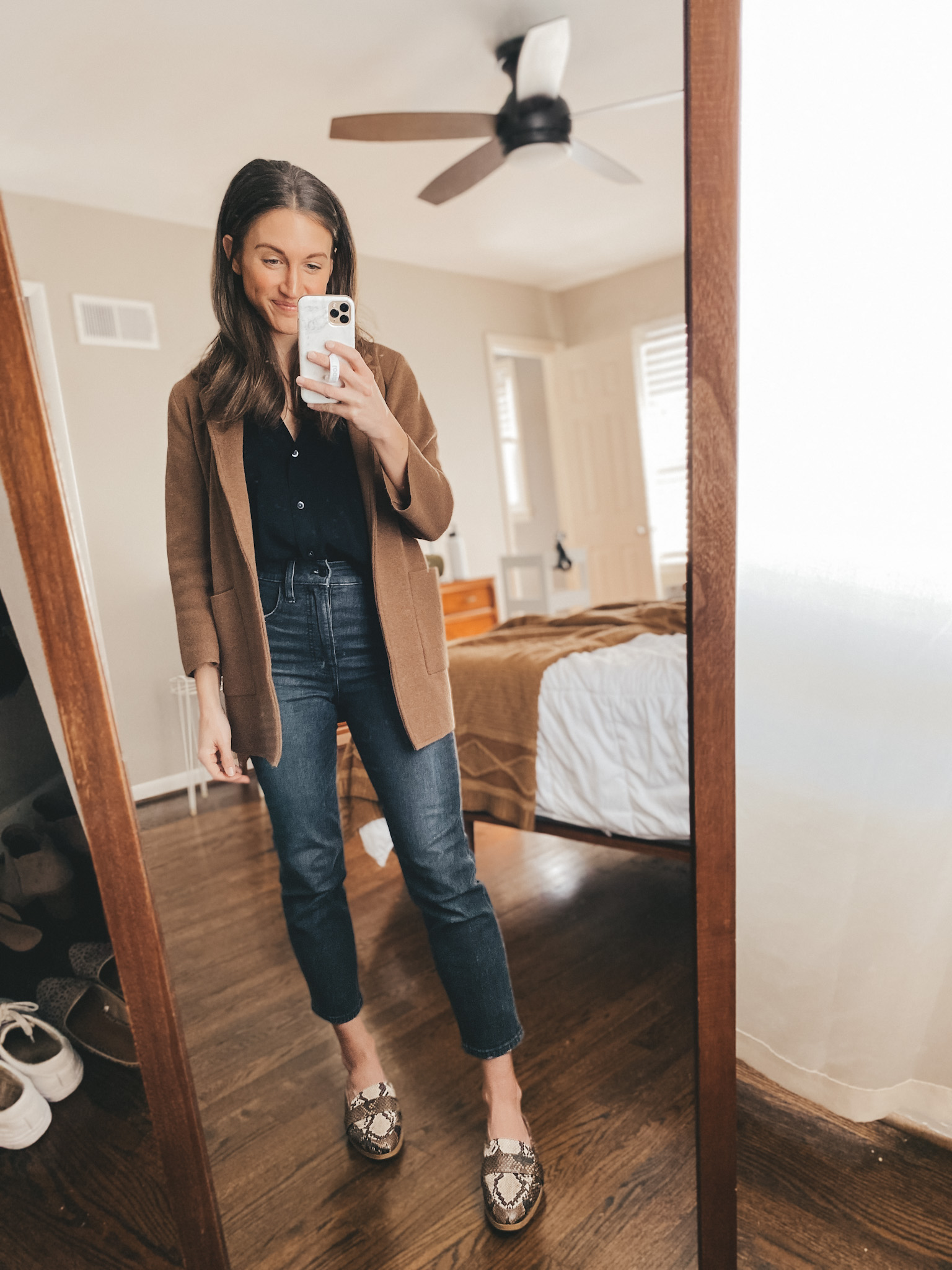 ashley wearing a black drapey button down from Madewell under a J.Crew sweater blazer with washed black jeans from Madewell and snakeskin mules from Target