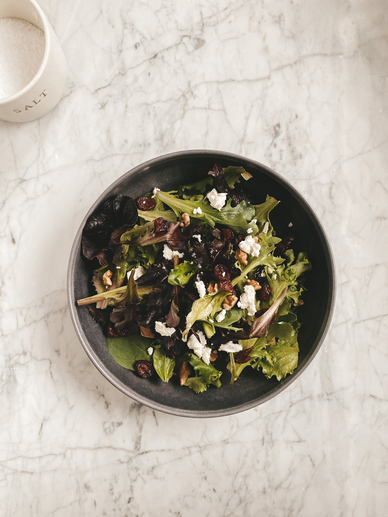 a salad in a gray bowl