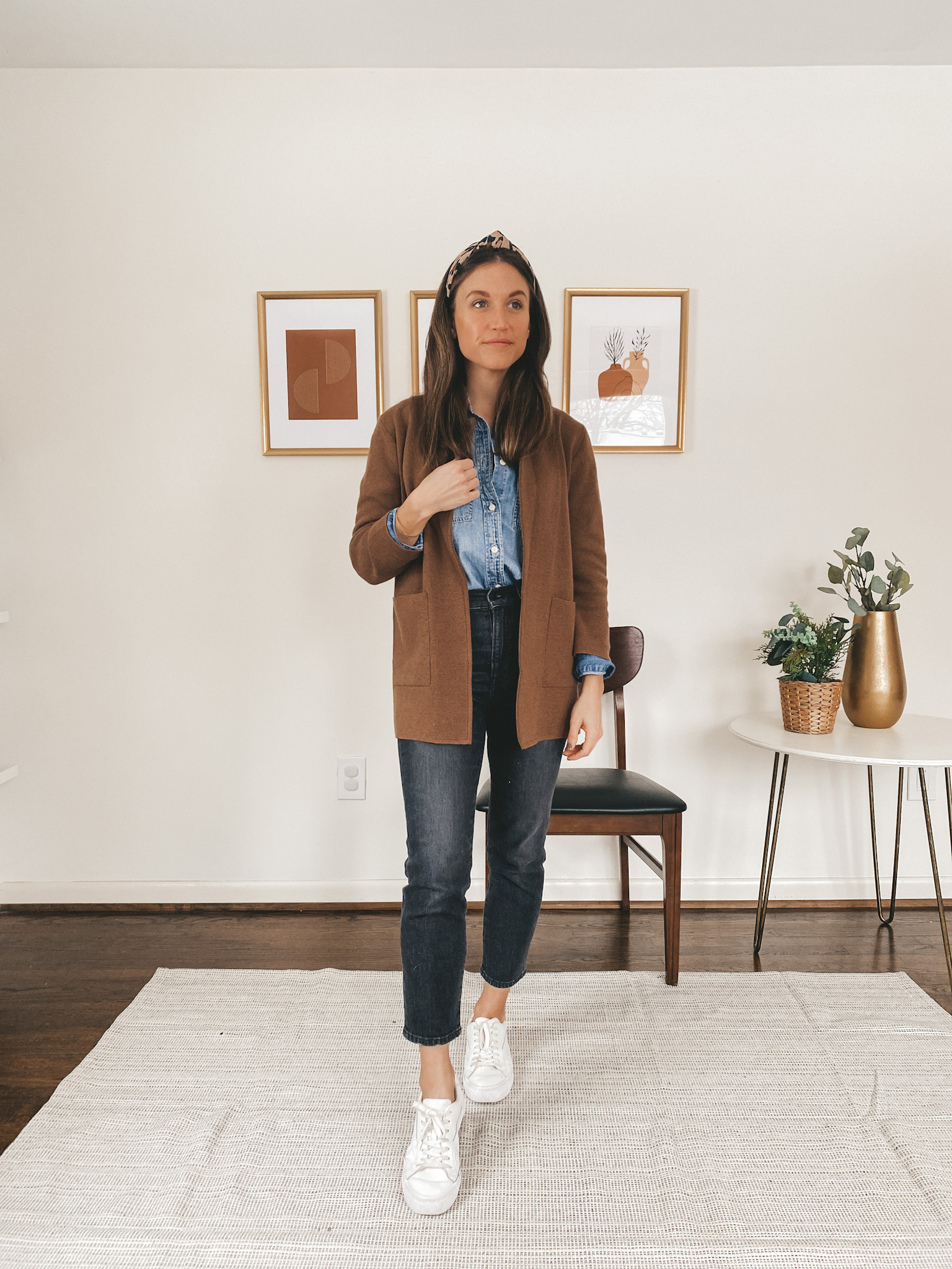 ashley wearing a chambray button down from J.Crew, a brown sweater blazer from J.Crew, washed black vintage jeans from Madewell, white sneakers from Madewell and a leopard headband from J.Crew