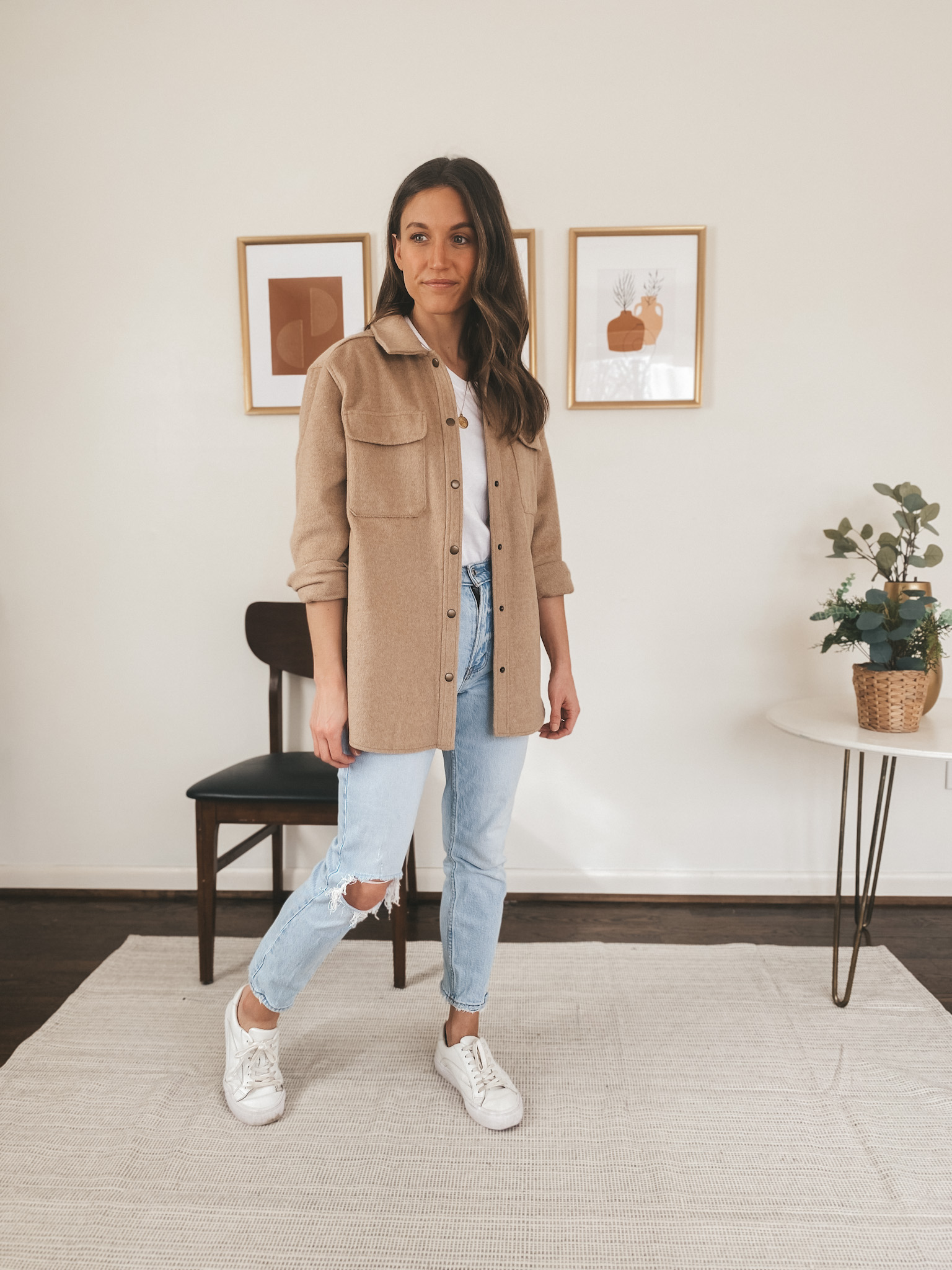 ashley wearing a tan colored shacket from Old Navy, mom jeans from Abercrombie, an Everlane white tee, and Madewell white sneakers