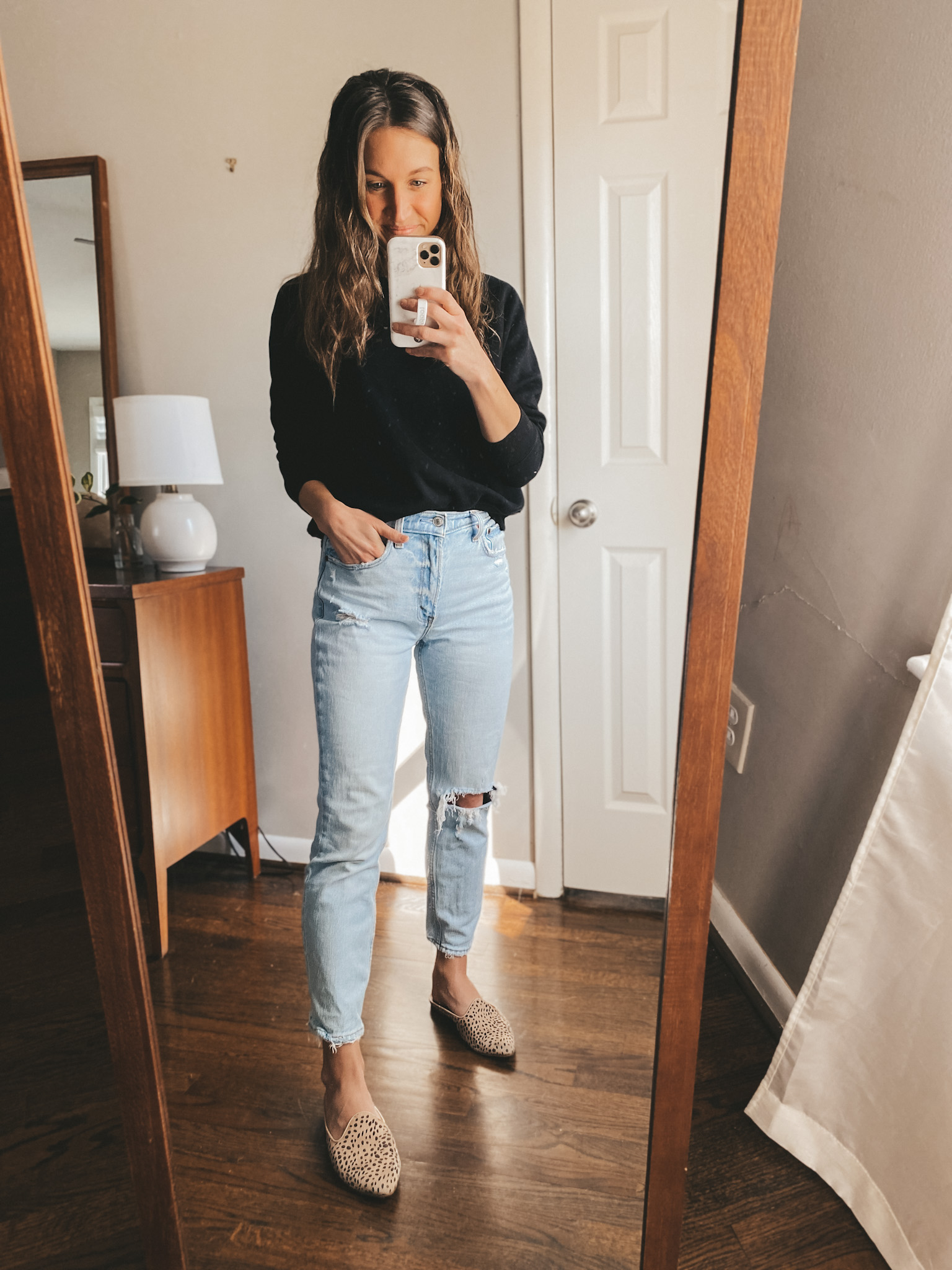 a mirror selfie; ashley wearing a black Old Navy crew neck sweater, Abercrombie mom jeans, and Target leopard mules