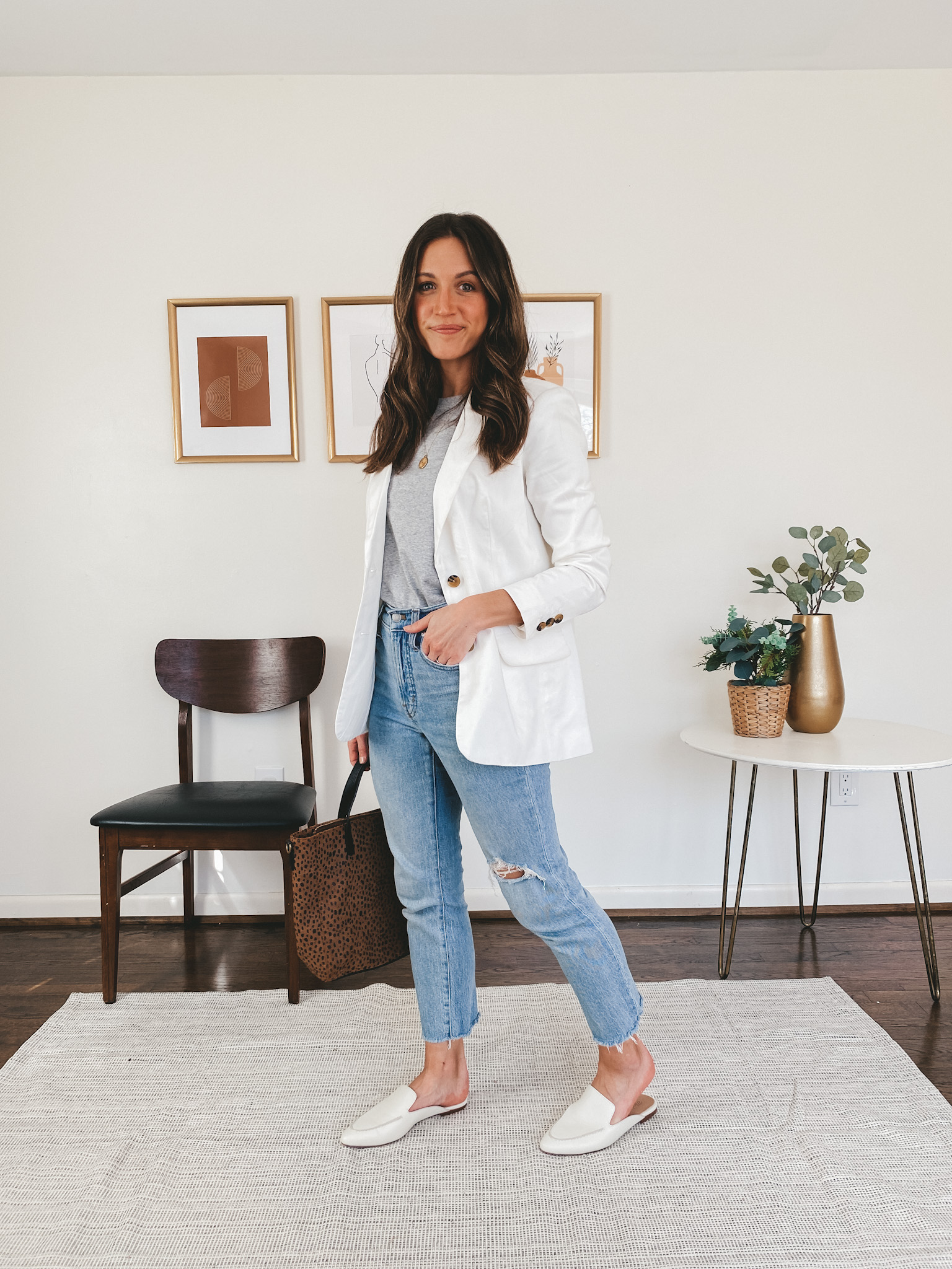 ashley wearing an Everlane gray tee, a Walmart Free Assembly white blazer, Madewell Perfect Vintage Jean and Madewell white mules carrying a leopard purse