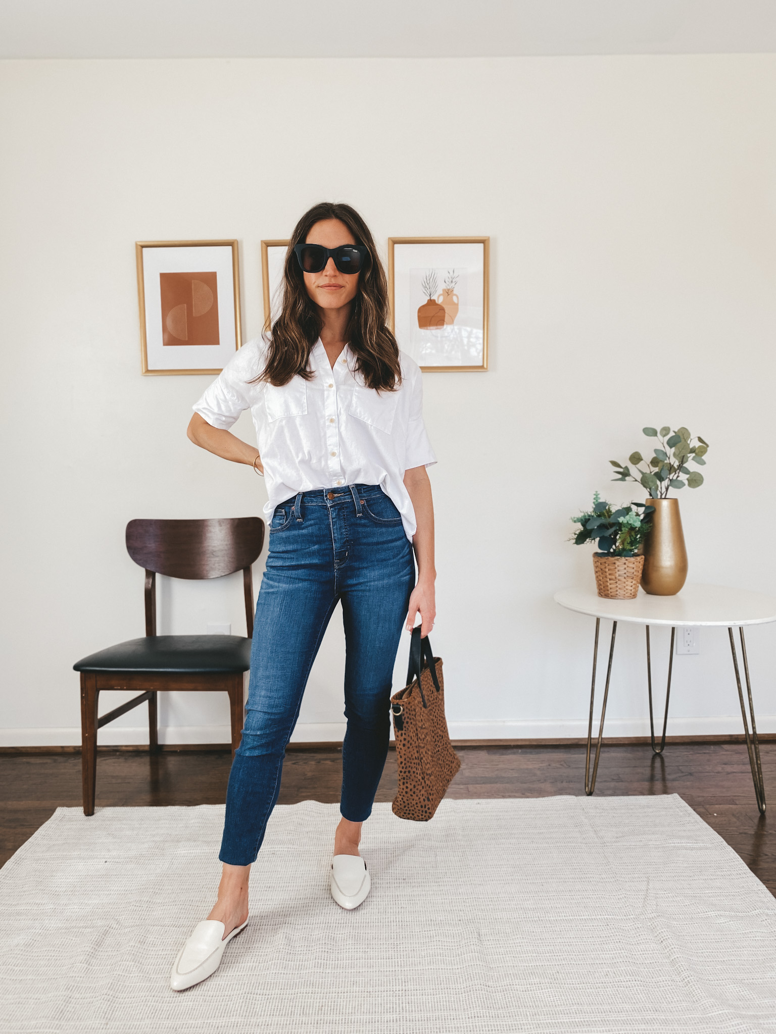 ashley wearing a Madewell white button down, Madewell skinny jeans, Madewell white mules and a Target leopard tote bag