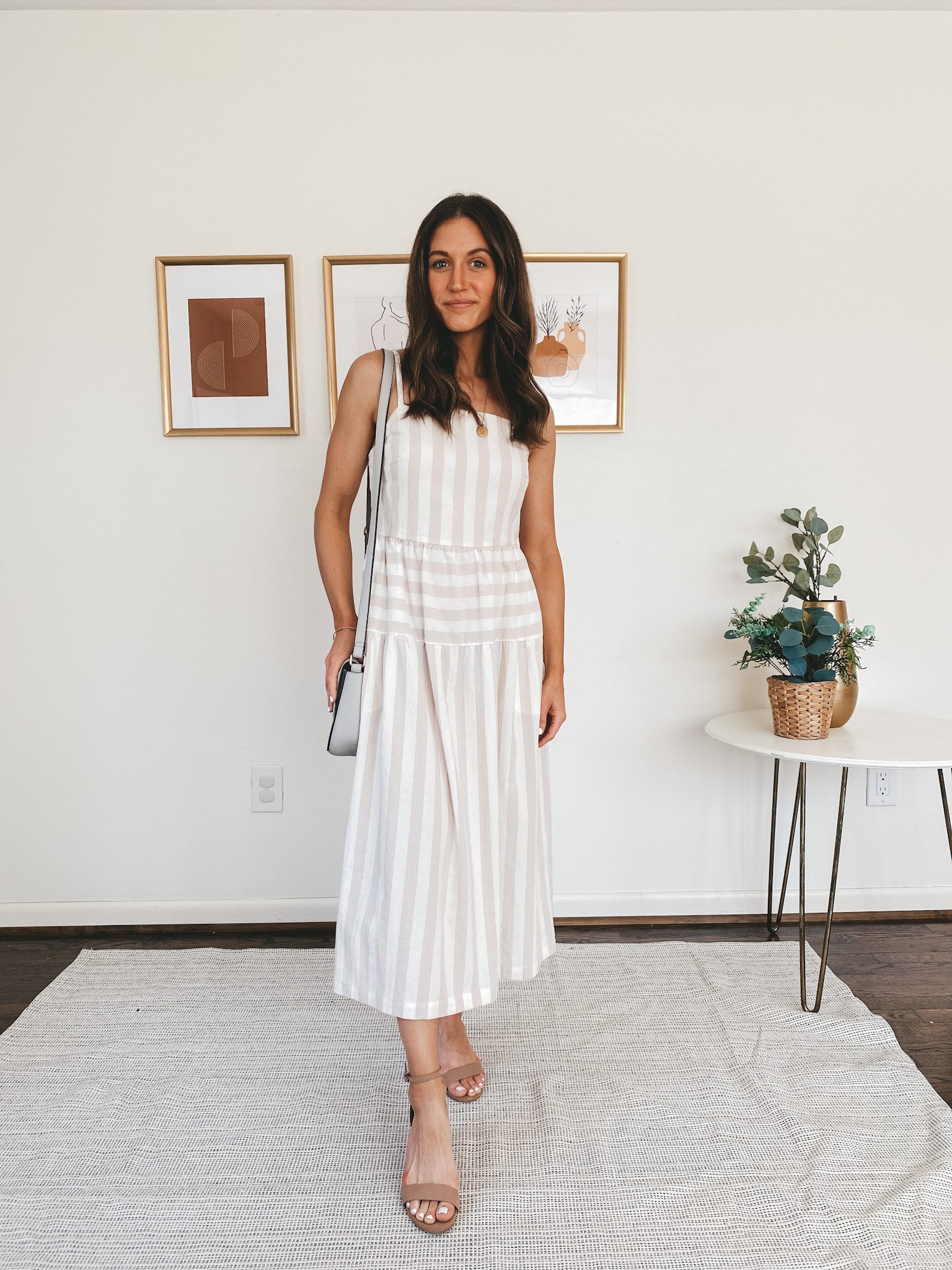 ashley wearing a Target tan and white striped midi dress with tan block heeled sandals, and a gray crossbody purse