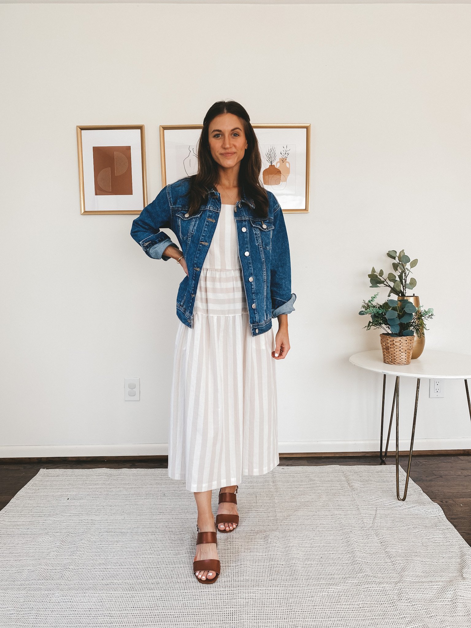 ashley wearing an oversized denim jacket from Old Navy, a Target white and tan striped midi dress, and Old Navy block heel sandals