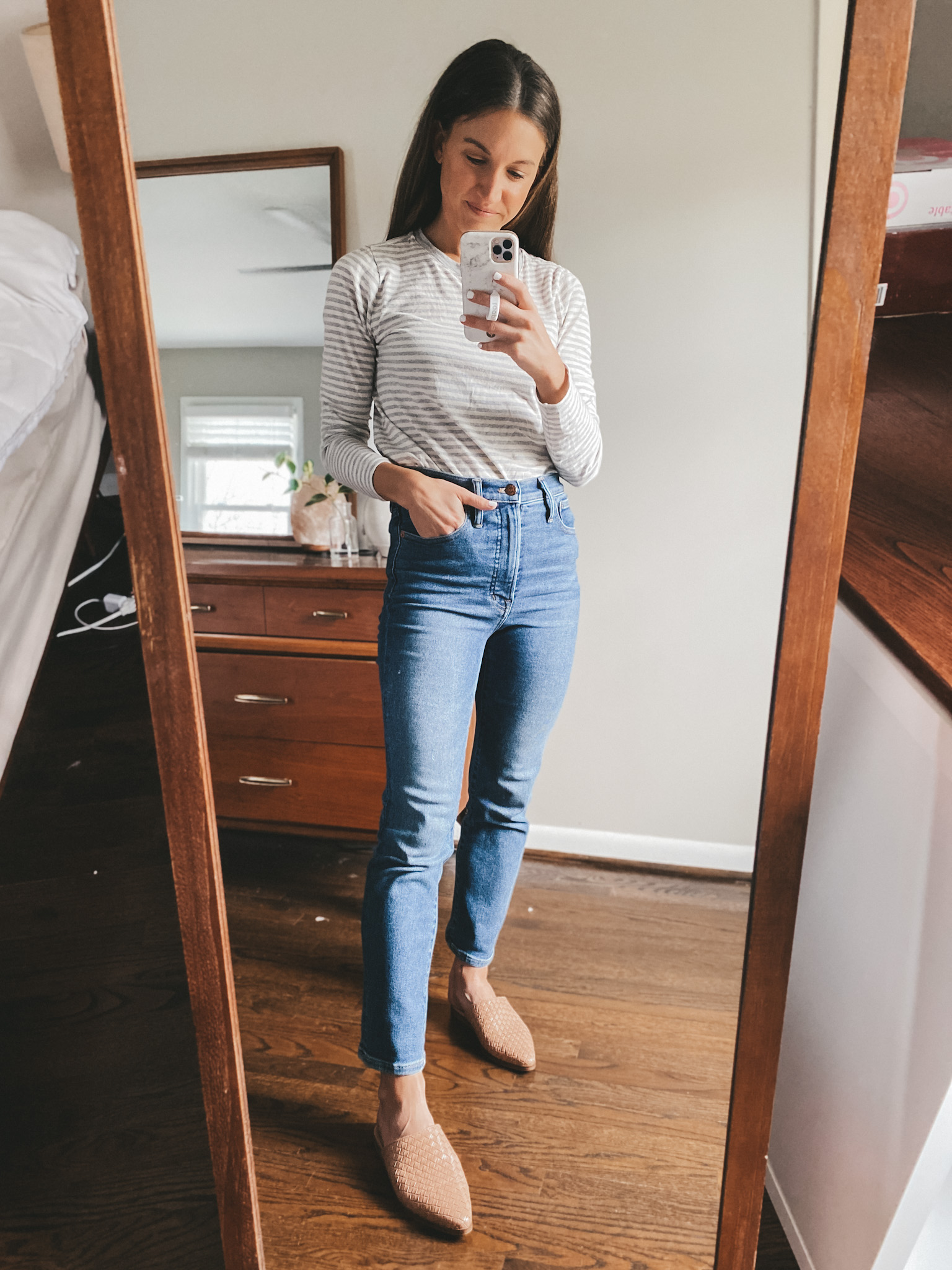 ashley wearing a gray and cream striped tee, Madewell Perfect Vintage Jeans and tan woven mules