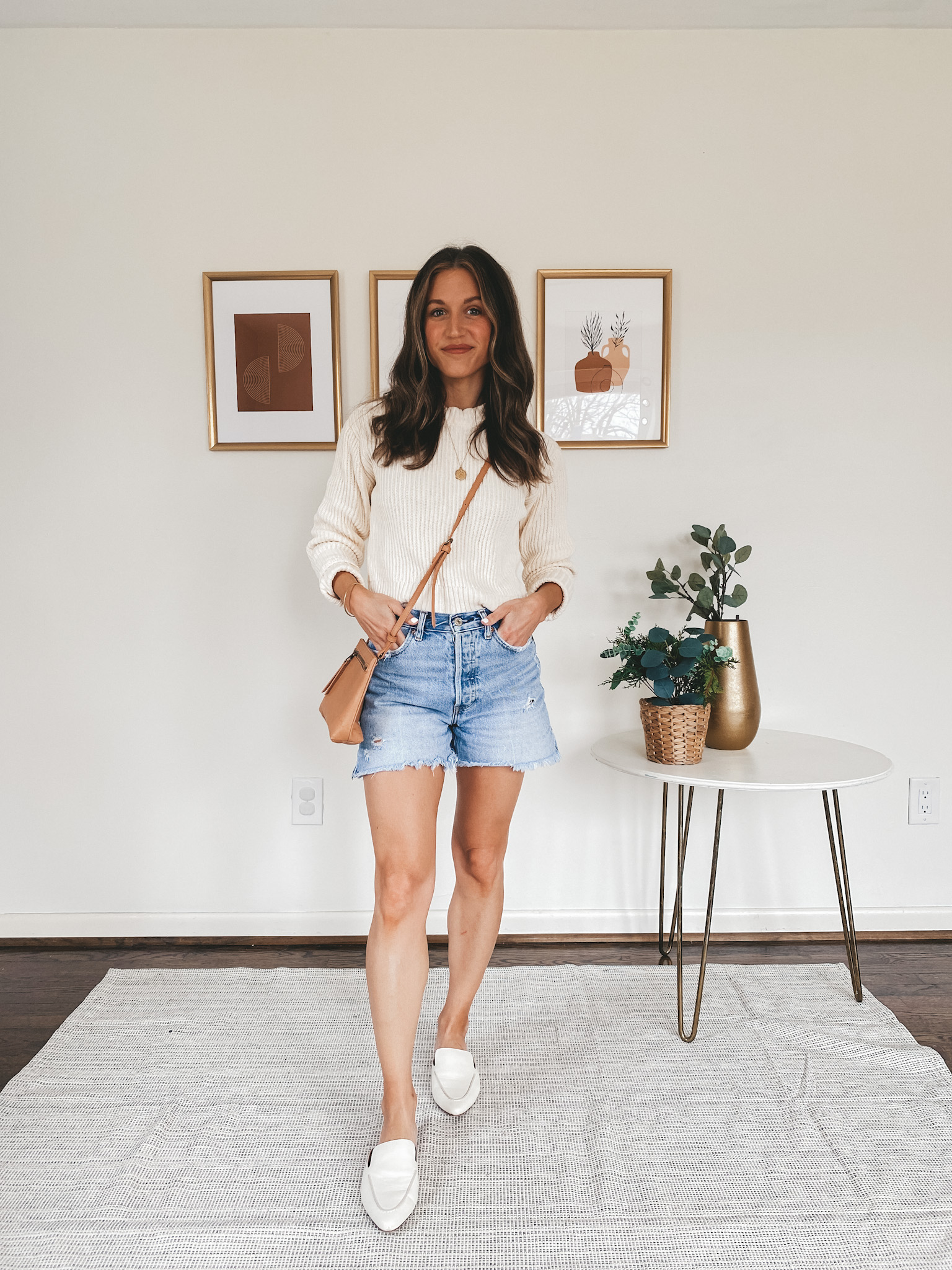 ashley wearing a Free Assembly from Walmart Cream Sweater, Abercrombie High Rise Mom Jeans, Madewell white mules and a camel crossbody bag from Target