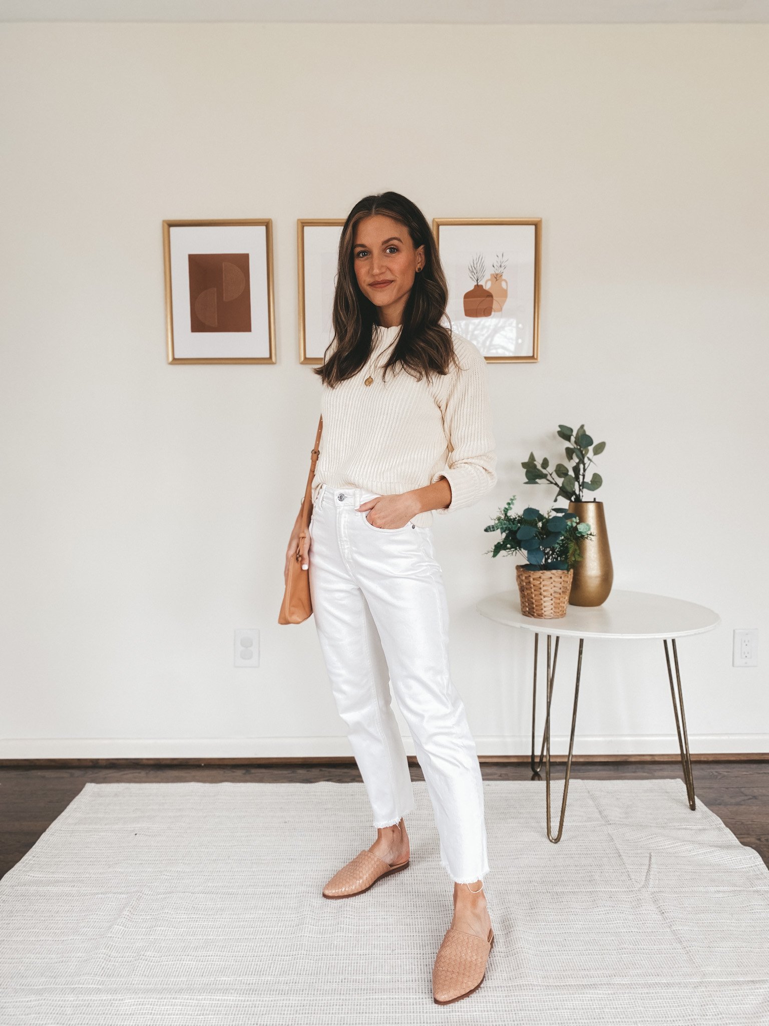 ashley wearing a Free Assembly cream sweater from Walmart, Everlane straight leg jeans, and Marc Fisher tan woven mules carrying a camel crossbody bag from Target