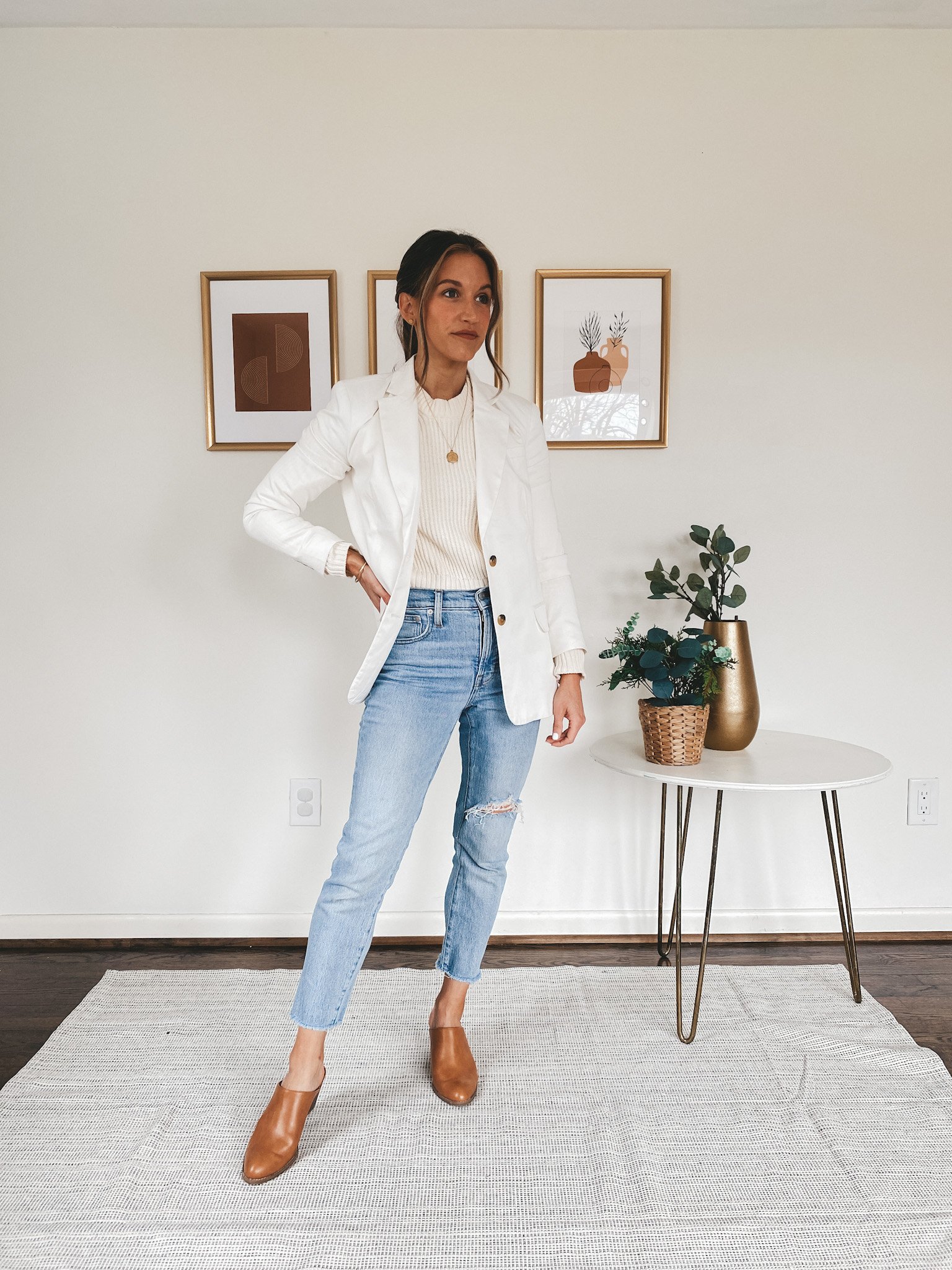 ashley wearing a Free Assembly cream sweater from Walmart a Free Assembly white blazer from Walmart, light wash Perfect Vintage Jeans from Madewell, and Old Navy cognac heeled mules