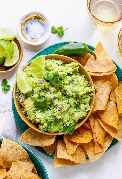 guacamole in a serving bowl with chips alongside