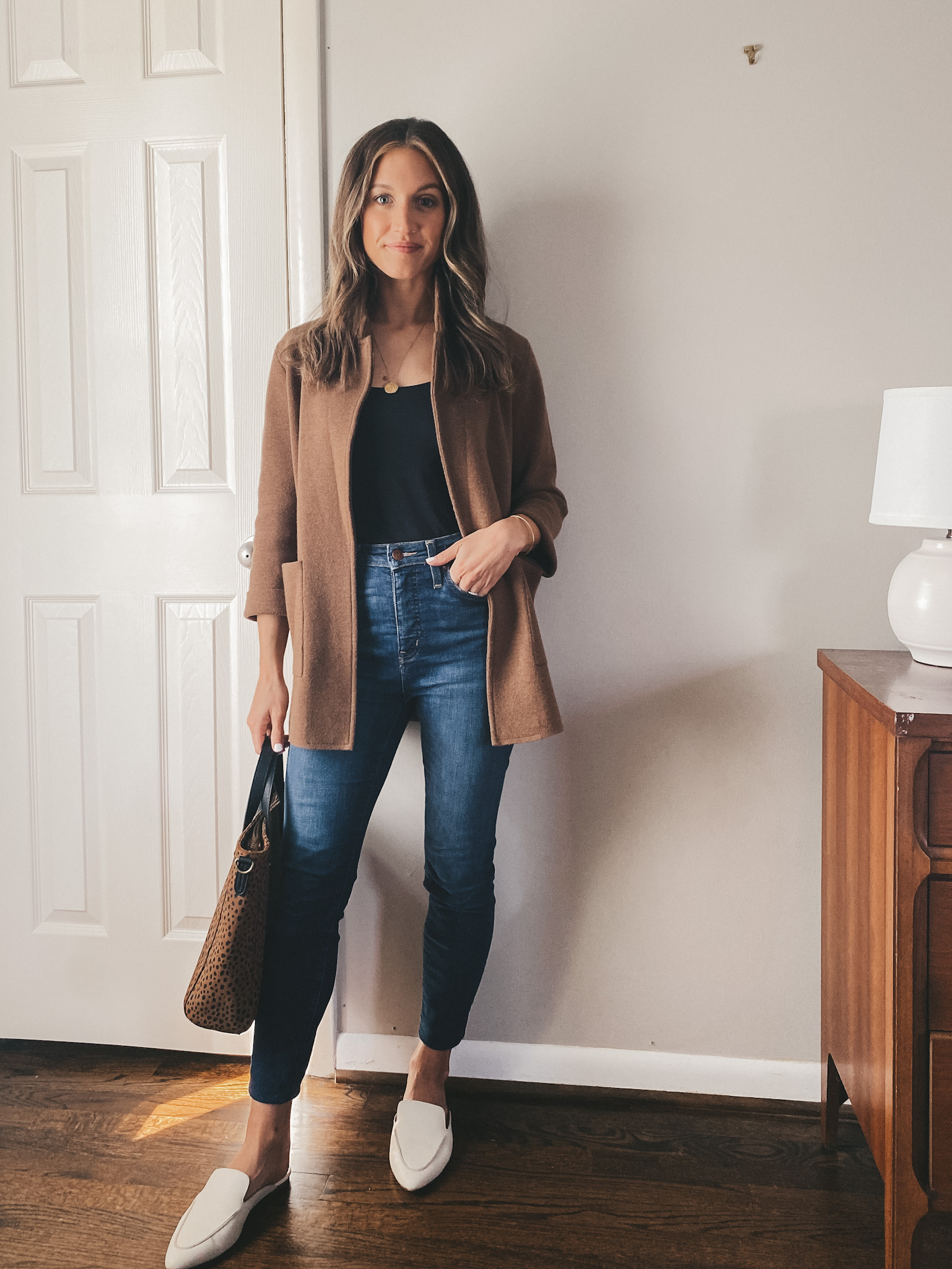 ashley wearing a black Everlane bodysuit, a brown J.Crew sweater blazer, Madewell skinny jeans and Madewell white mules with a Target leopard handbag