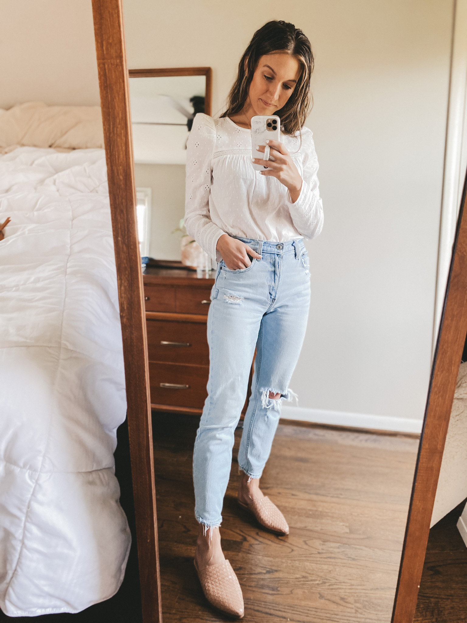 ashley wearing a long sleeved eyelet top from Target, Abercrombie mom jeans, and Marc Fisher tan woven mules