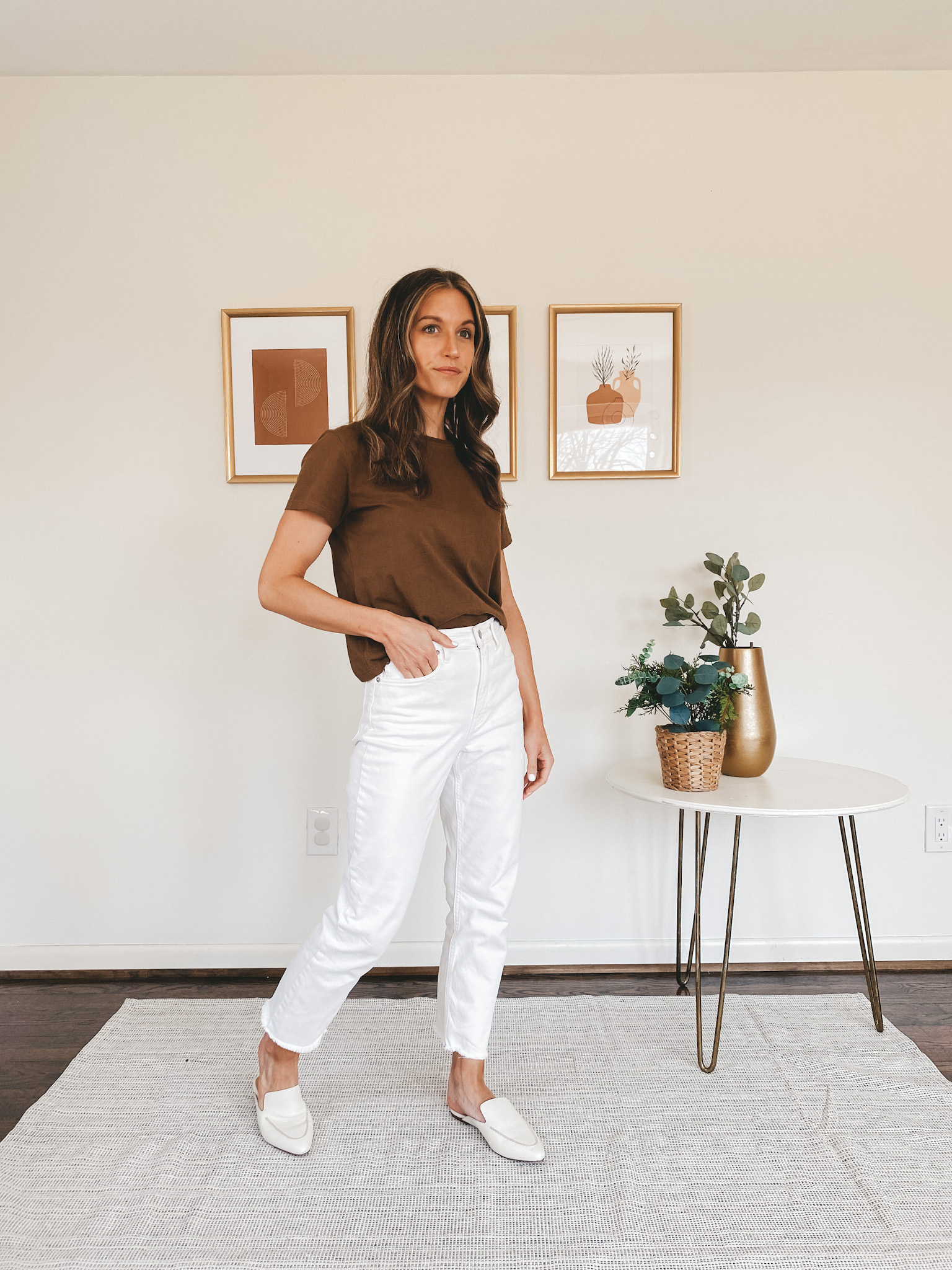 ashley wearing a brown tee, white jeans, and white mules