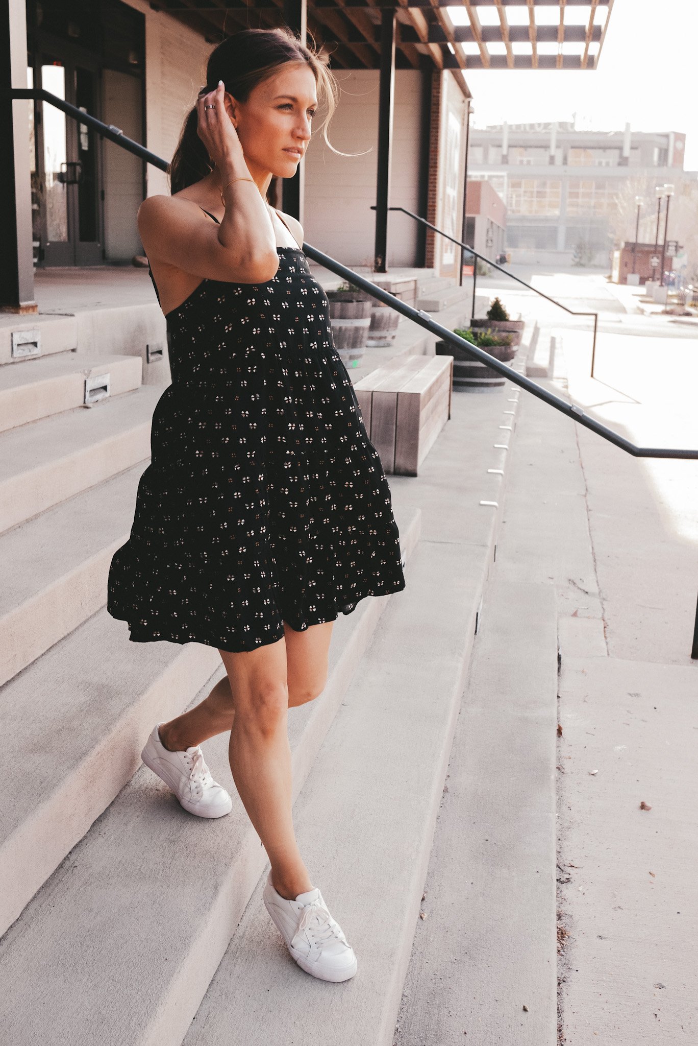 ashley walking down the stairs outside a building in downtown Kansas City