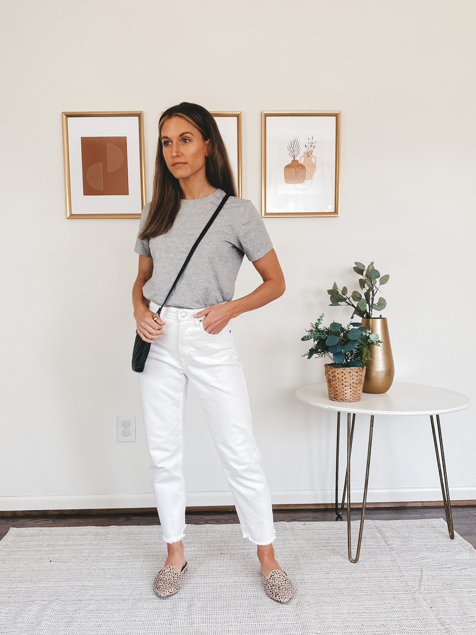 ashley wearing a gray tee, white denim and leopard mules