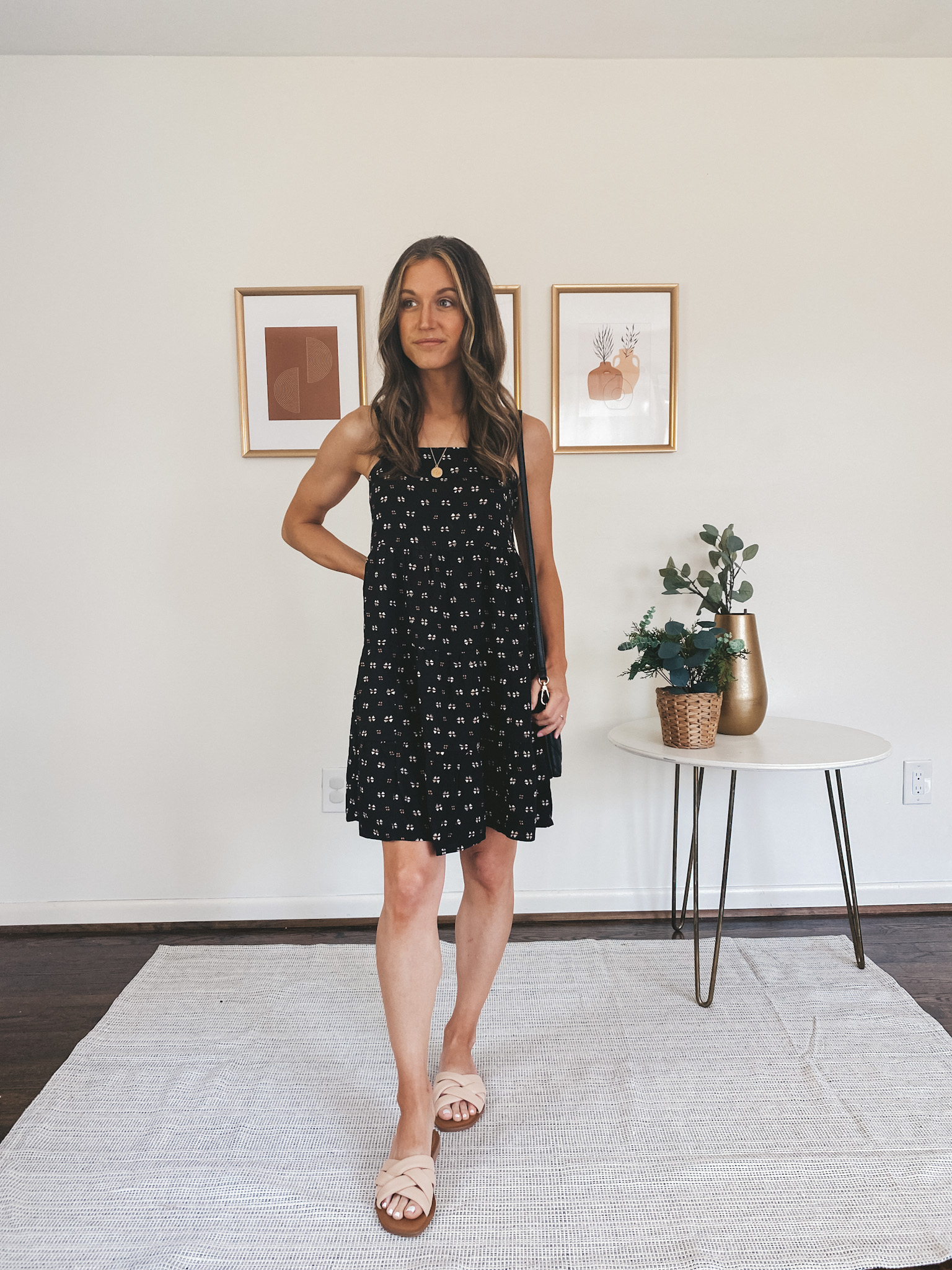 ashley wearing a black patterned tiered dress from Old Navy and padded slide sandals 