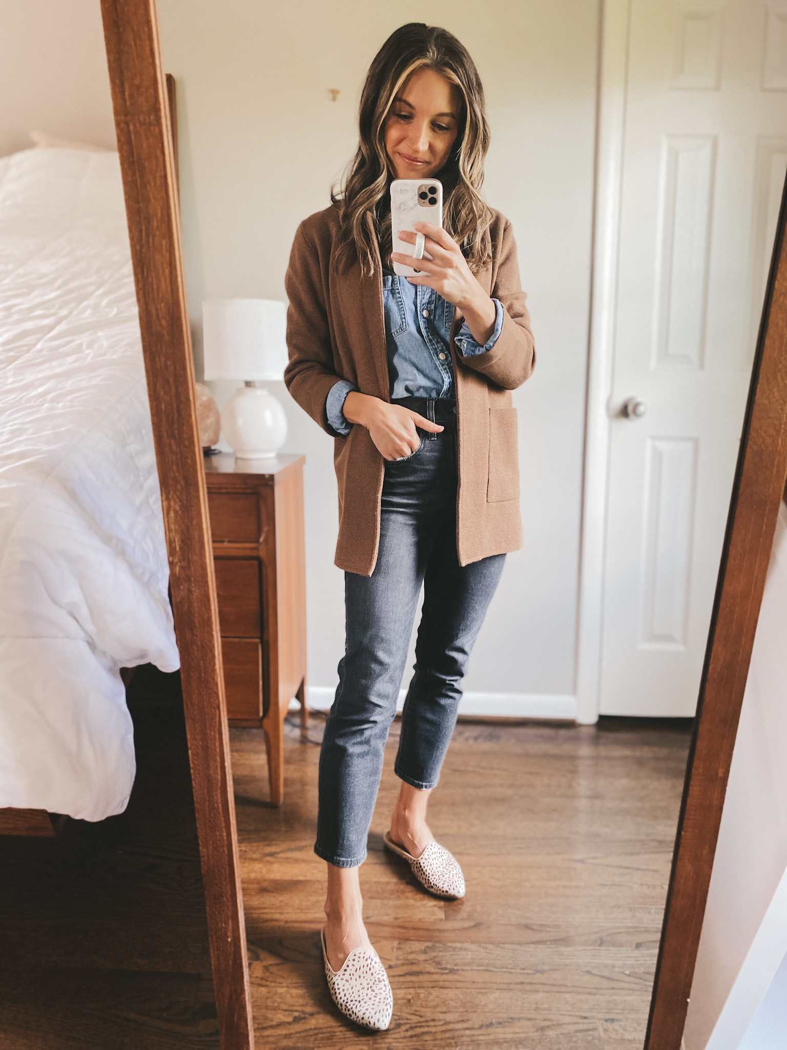 ashley wearing a chambray button down, brown sweater blazer, washed black jeans and leopard mules