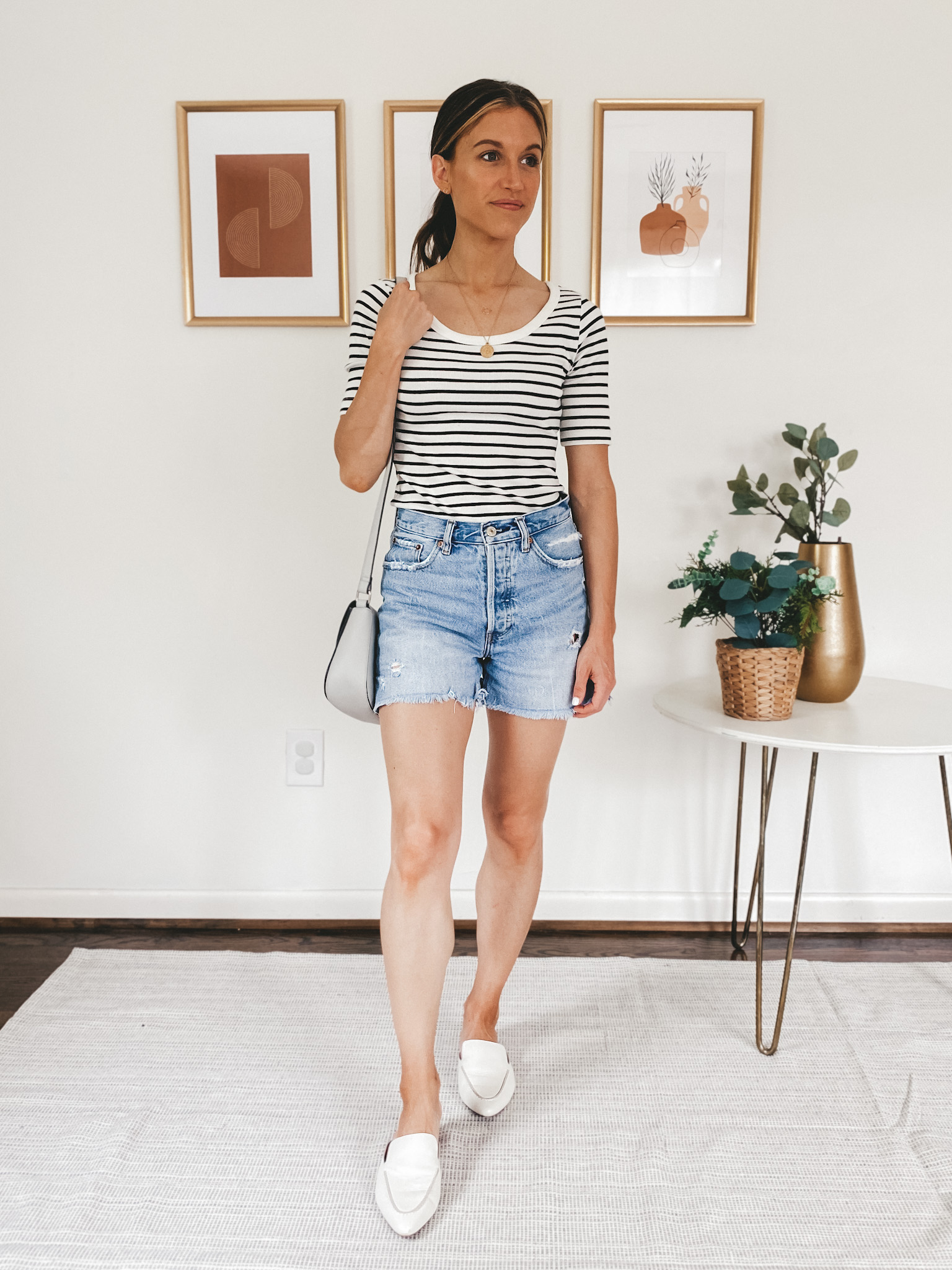 ashley wearing a striped tee, denim cut off shorts and white mules