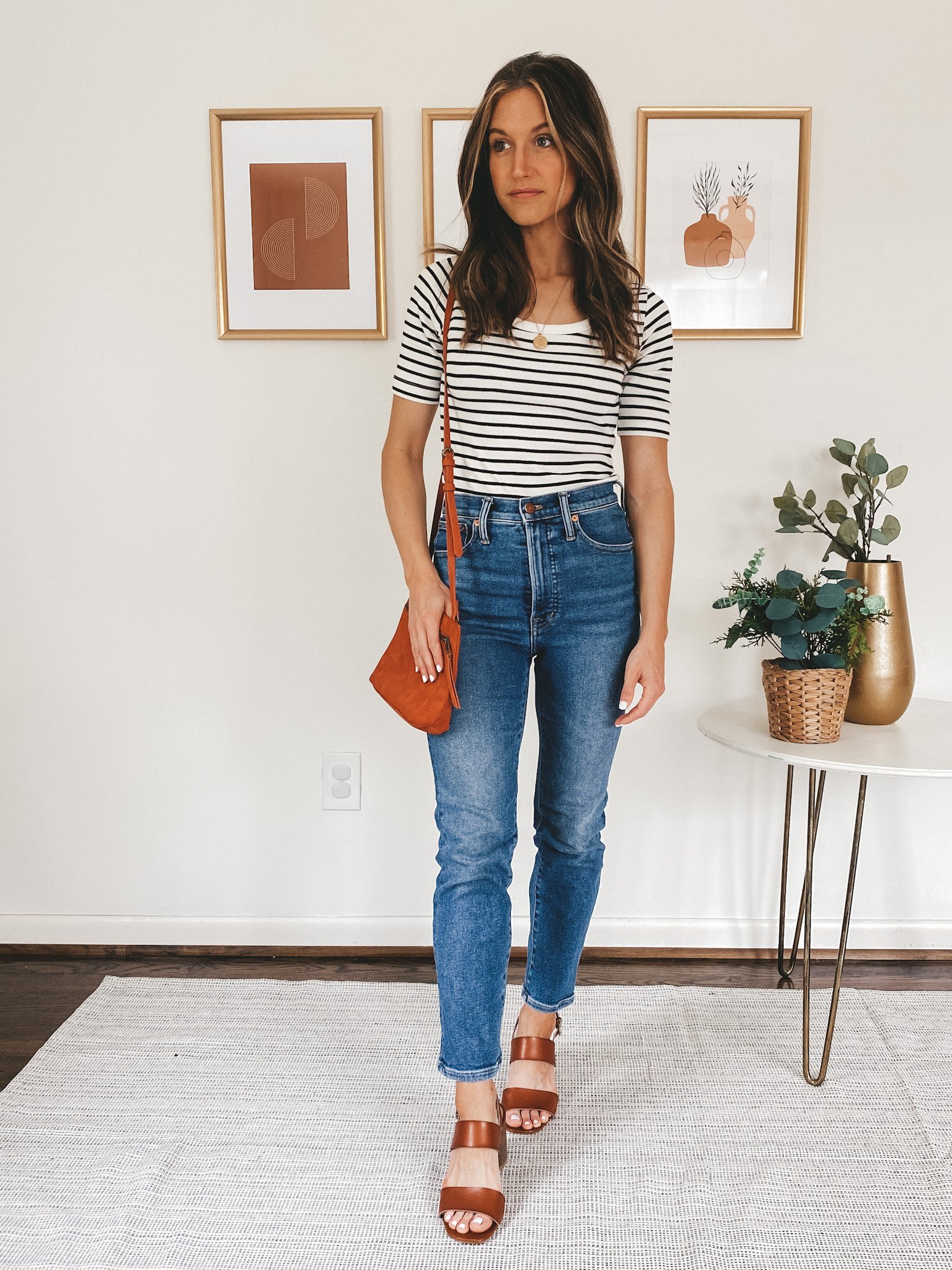 ashley wearing a striped tee, straight leg denim, and heeled block sandals