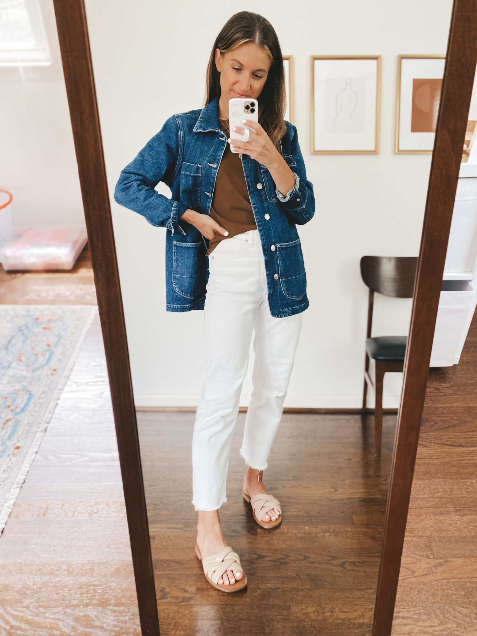 ashley wearing a brown tee, denim chore jacket, white jeans, and nude padded slides