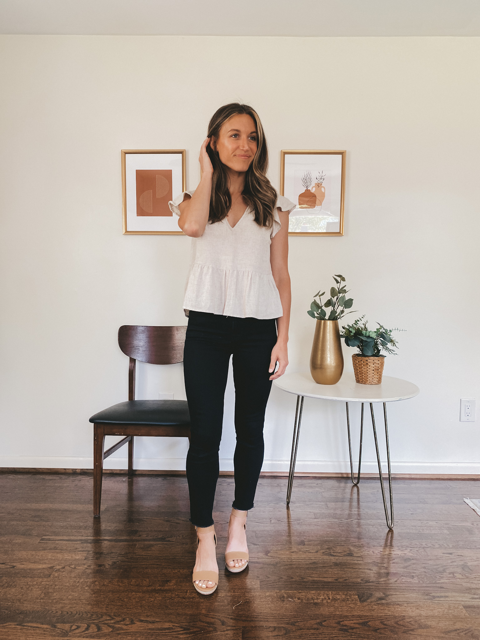 ashley wearing a linen blend flutter sleeve top, black skinny jeans and tan espadrilles