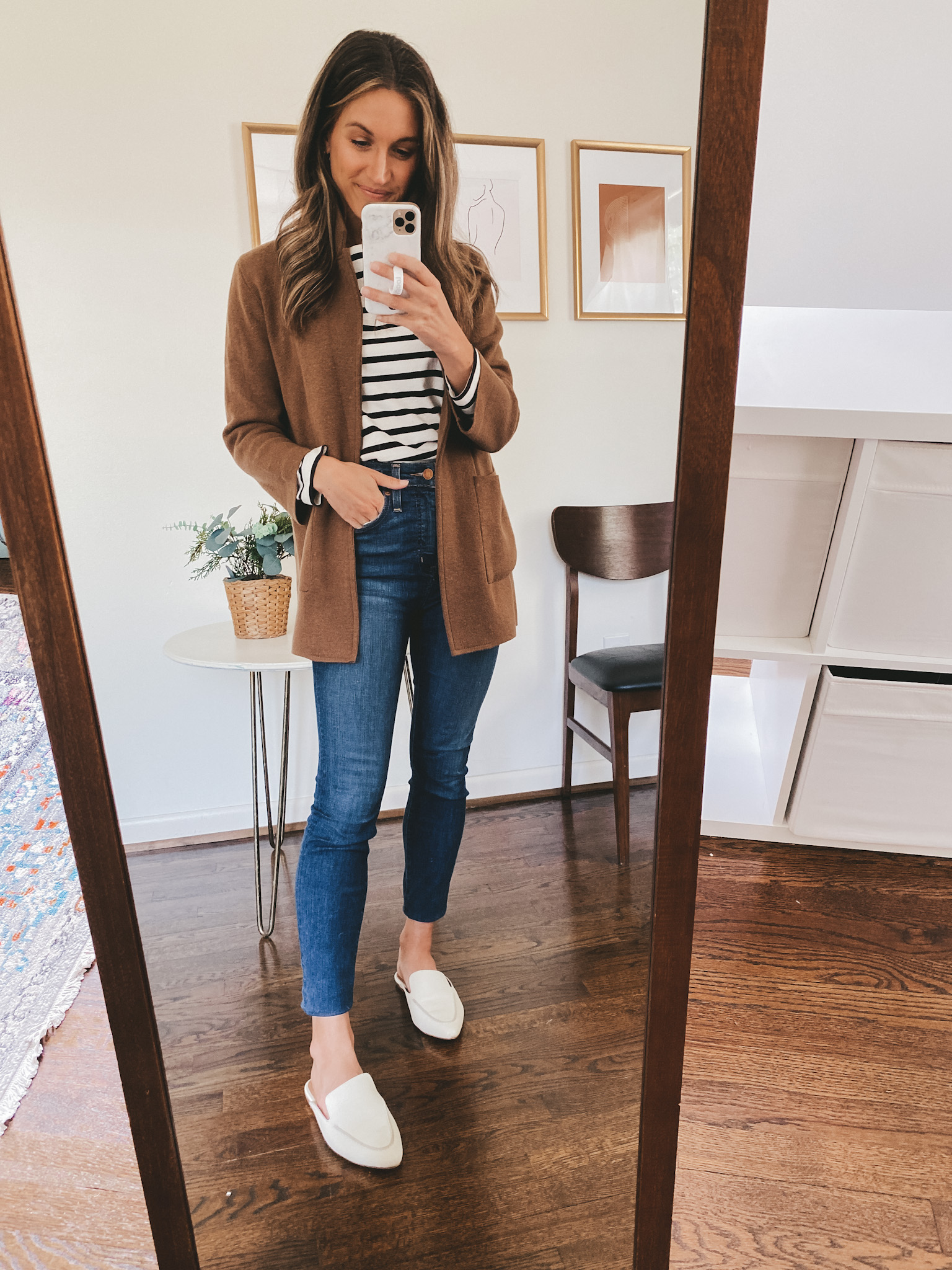 ashley wearing a striped breton top, brown sweater blazer, mid-wash skinny jeans, and white mules