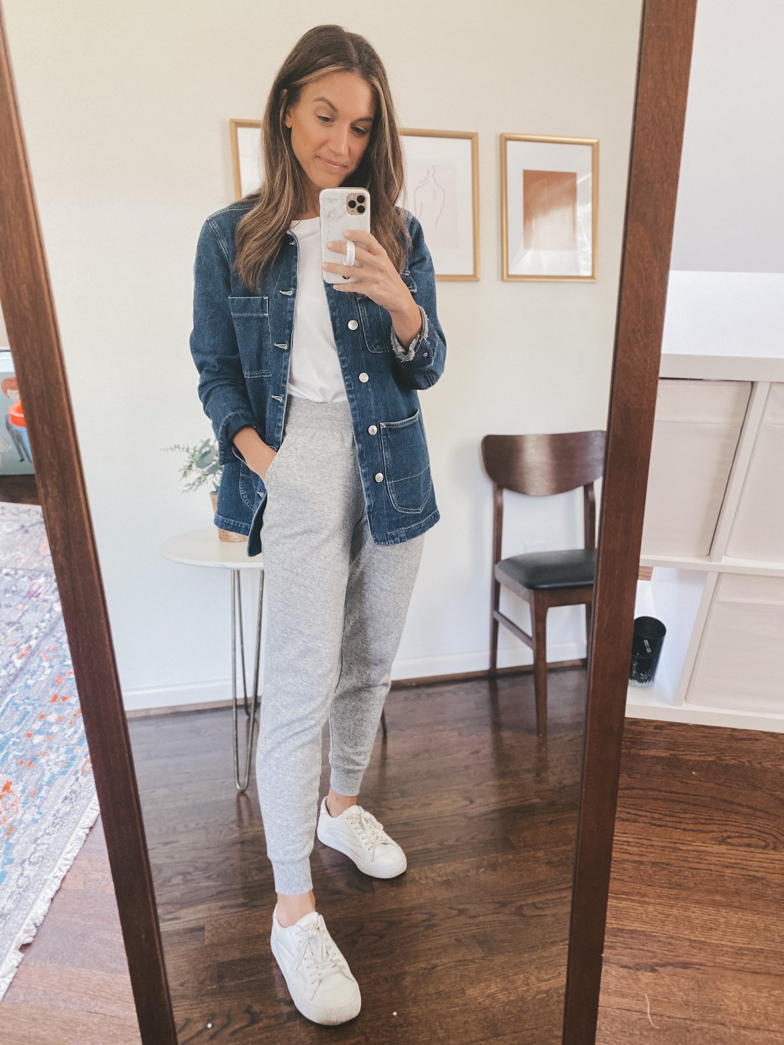 ashley wearing a white tee, denim chore jacket, gray joggers and white sneakers