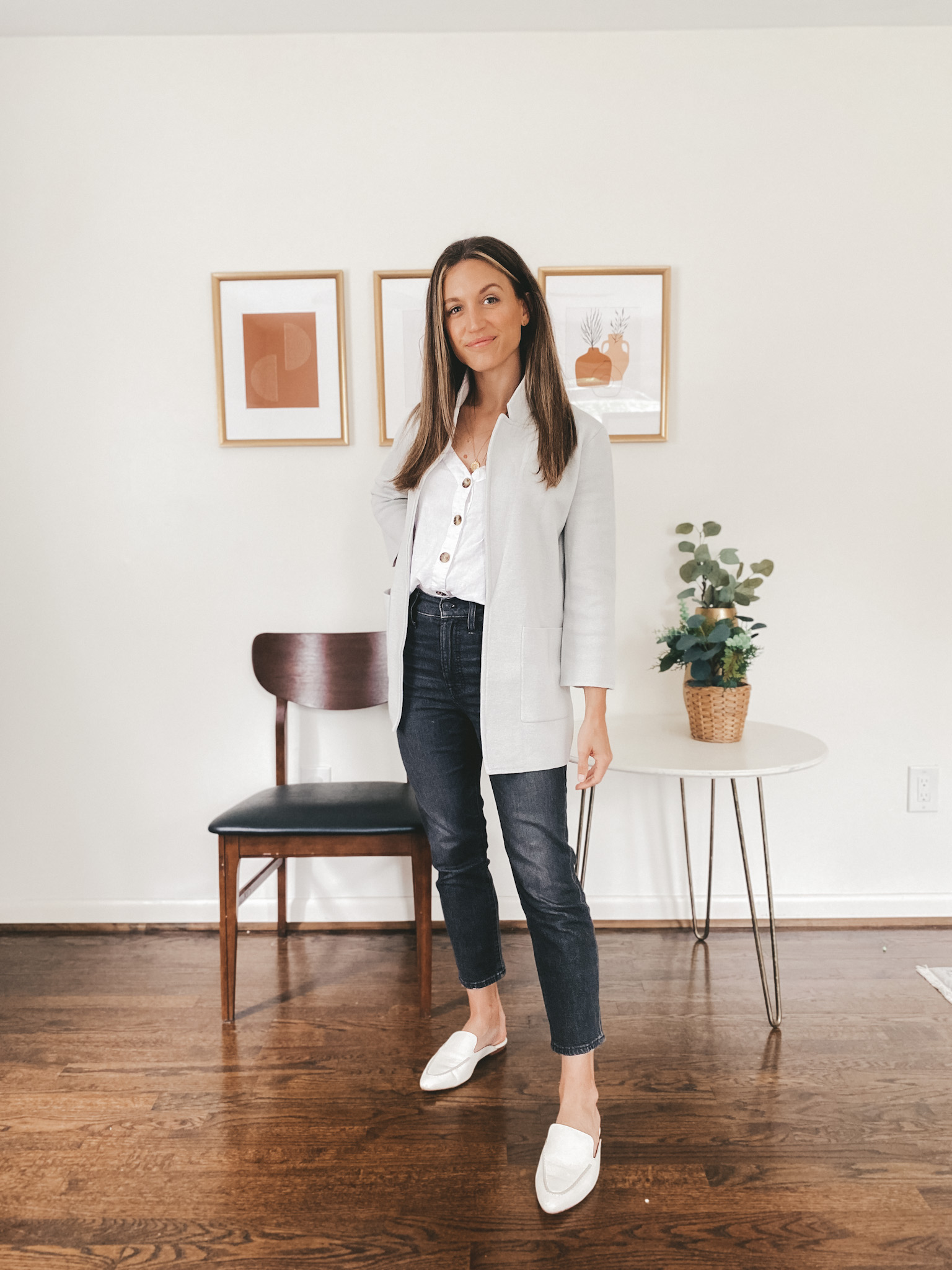 ashley wearing a button front linen tank, gray sweater blazer and washed black jeans with white mules