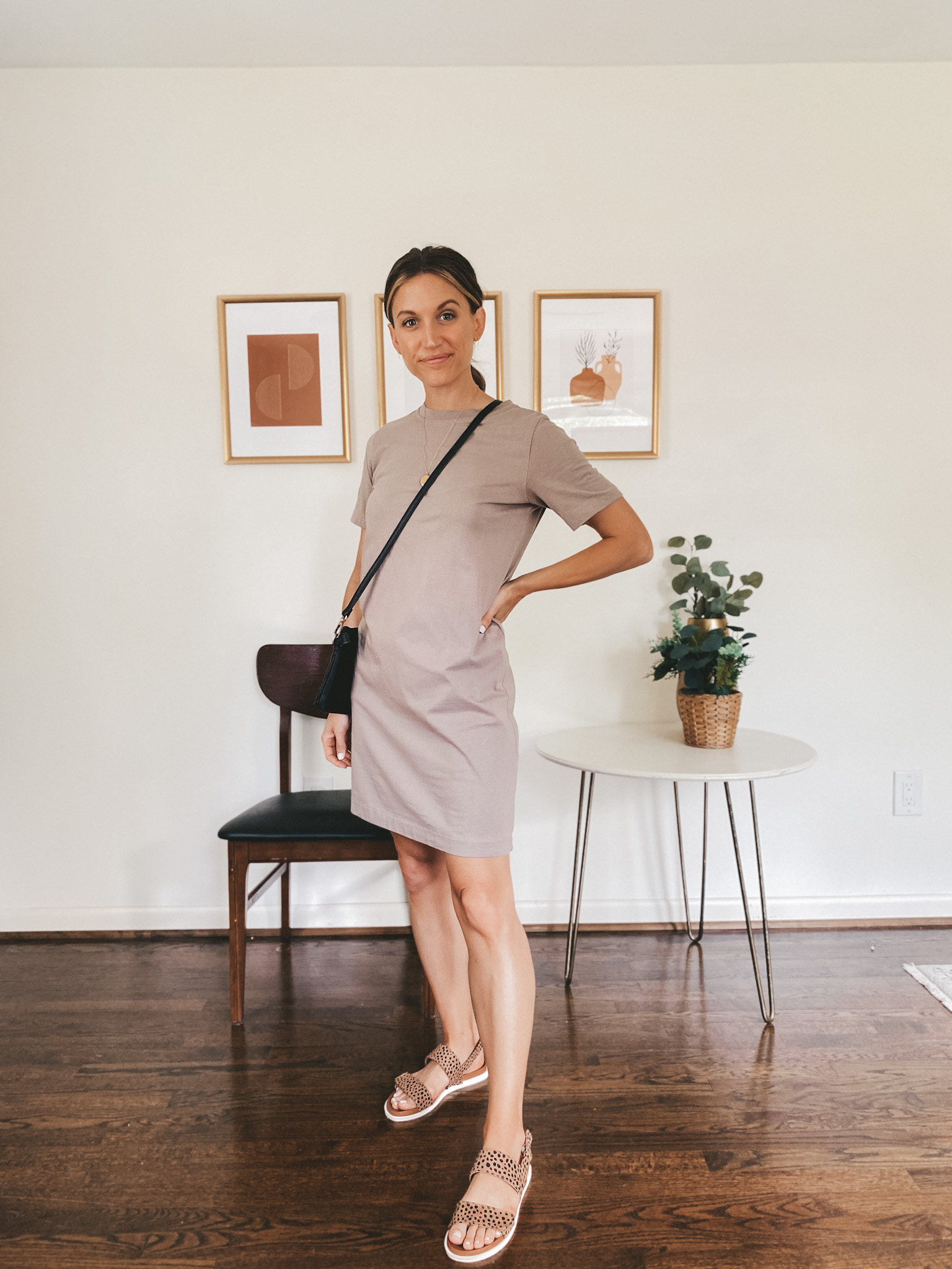 ashley wearing a taupe t-shirt dress, leopard print sandals and a black crossbody bag