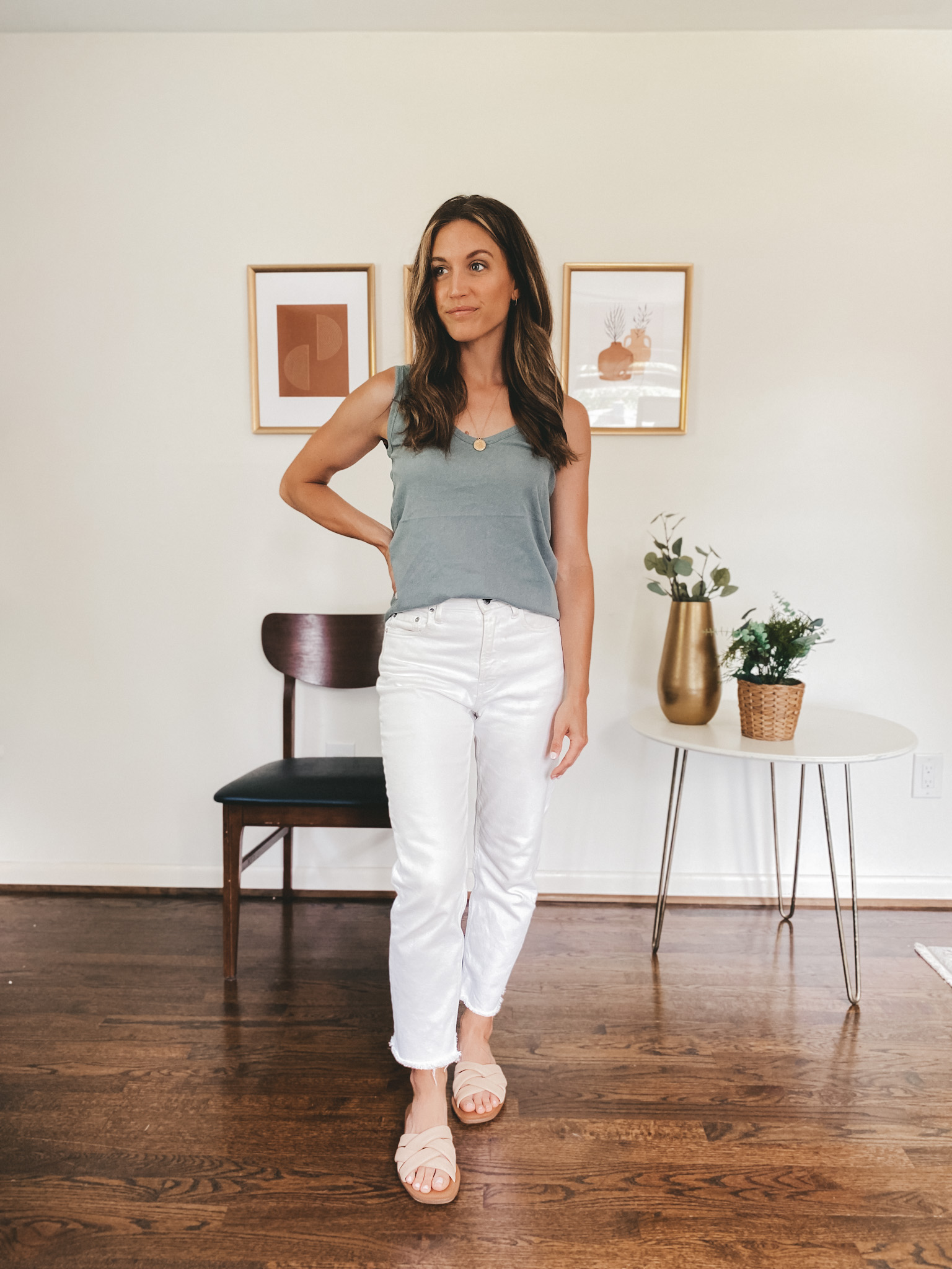 ashley wearing a blue tank, white denim and nude padded sandals
