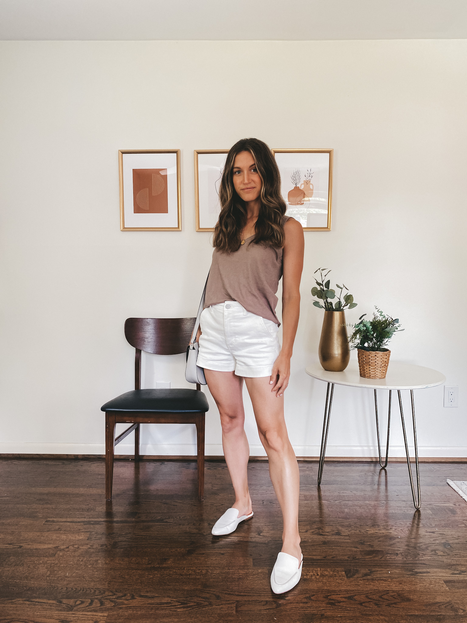 ashley wearing a taupe tank, white shorts and white mules