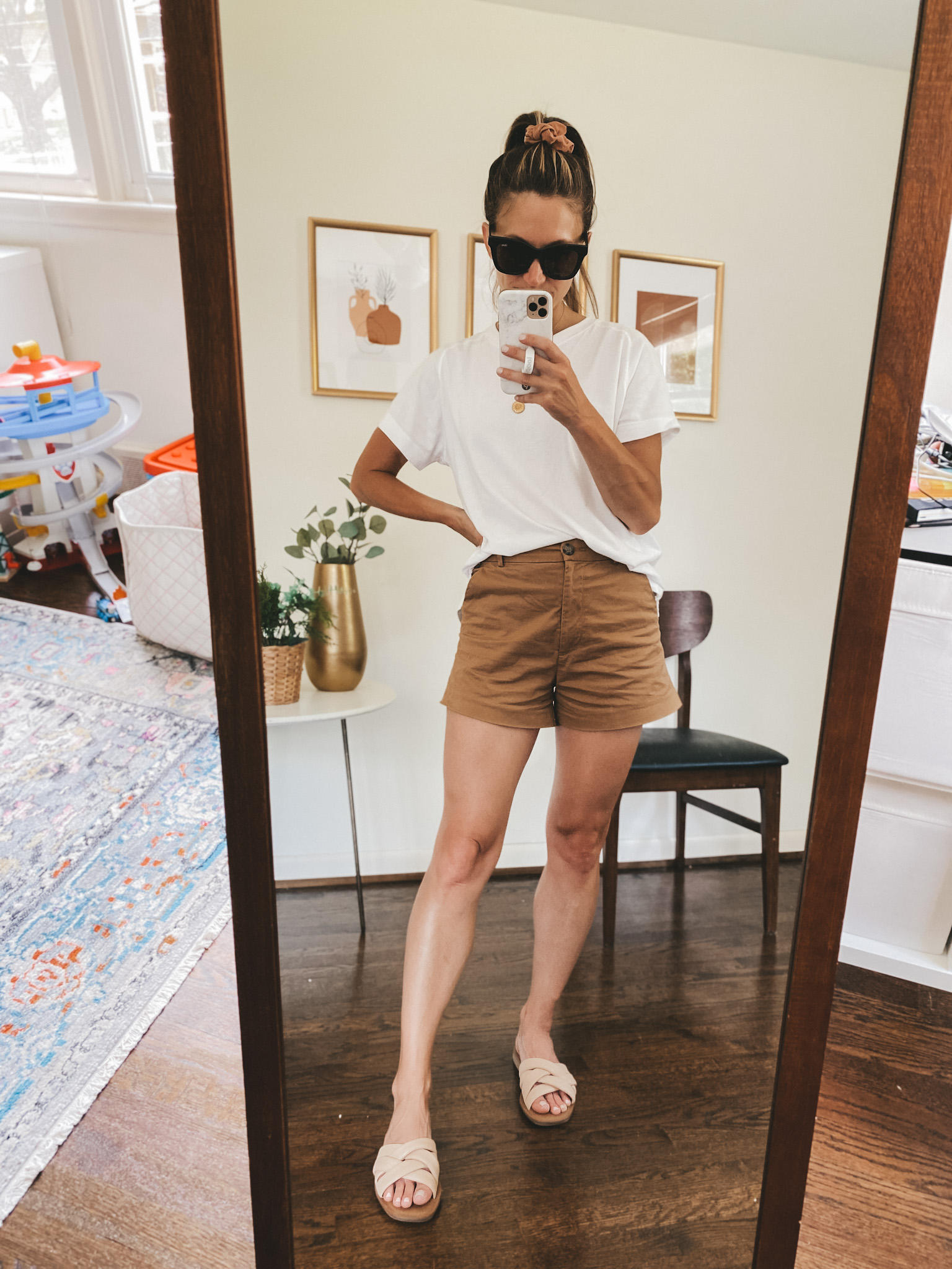 ashley wearing a white oversized tee, brown twill shorts and nude padded slides 