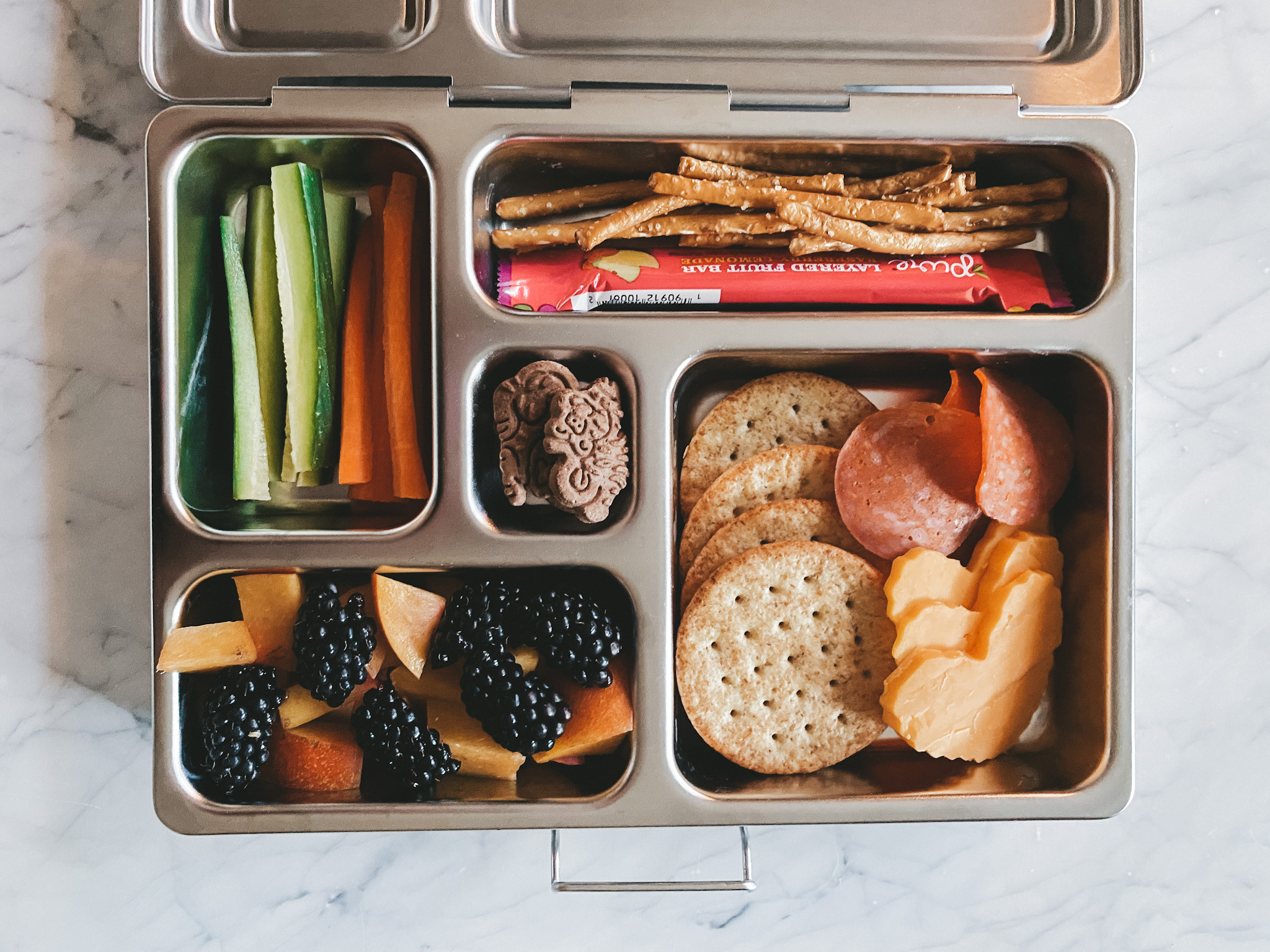 the Planet Box Rover Lunchbox filled with various food items