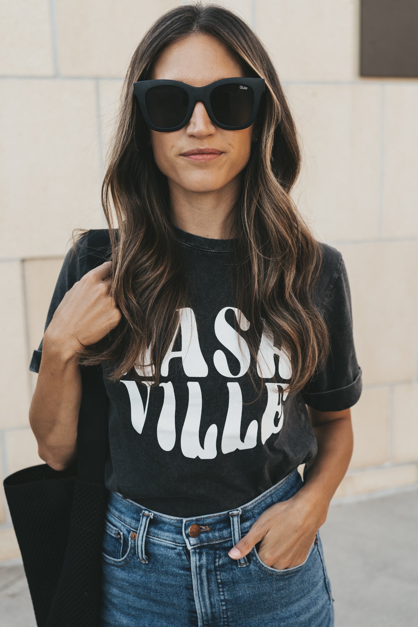 ashley wearing a black graphic tee from ABLE that reads
