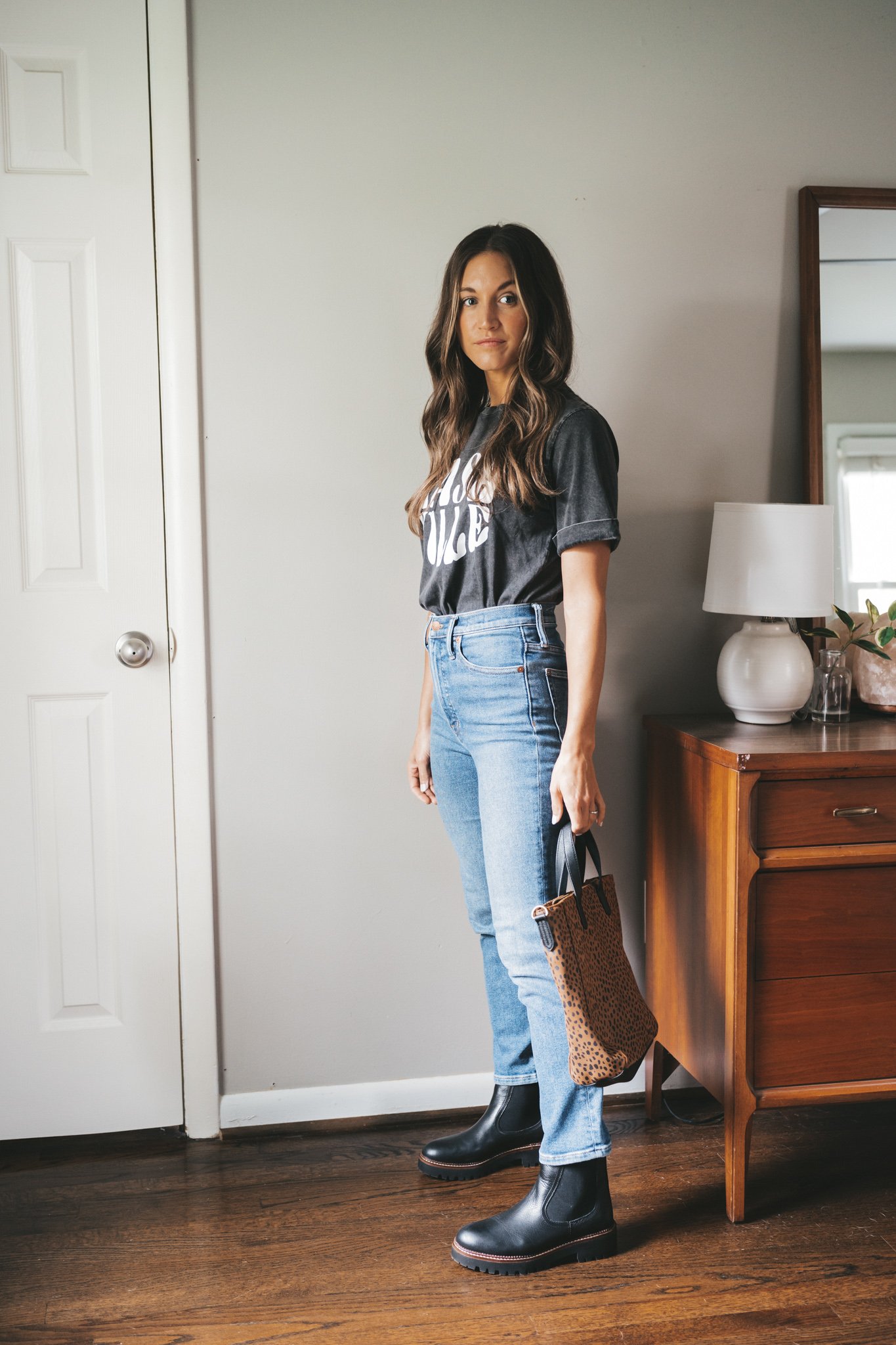 ashley wearing a washed black graphic tee that reads 