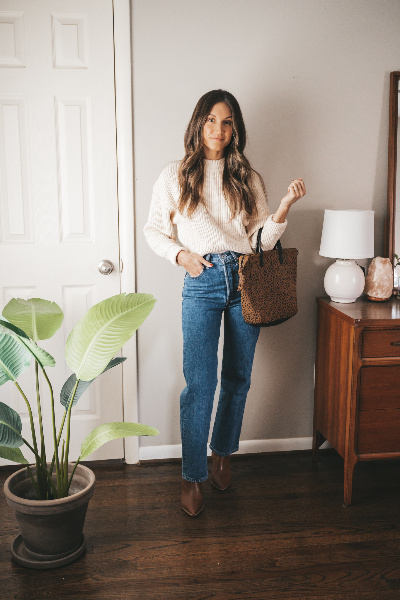 winter essential crewneck sweater worn with dark wash denim, cognac ankle boots, and a leopard print tote bag
