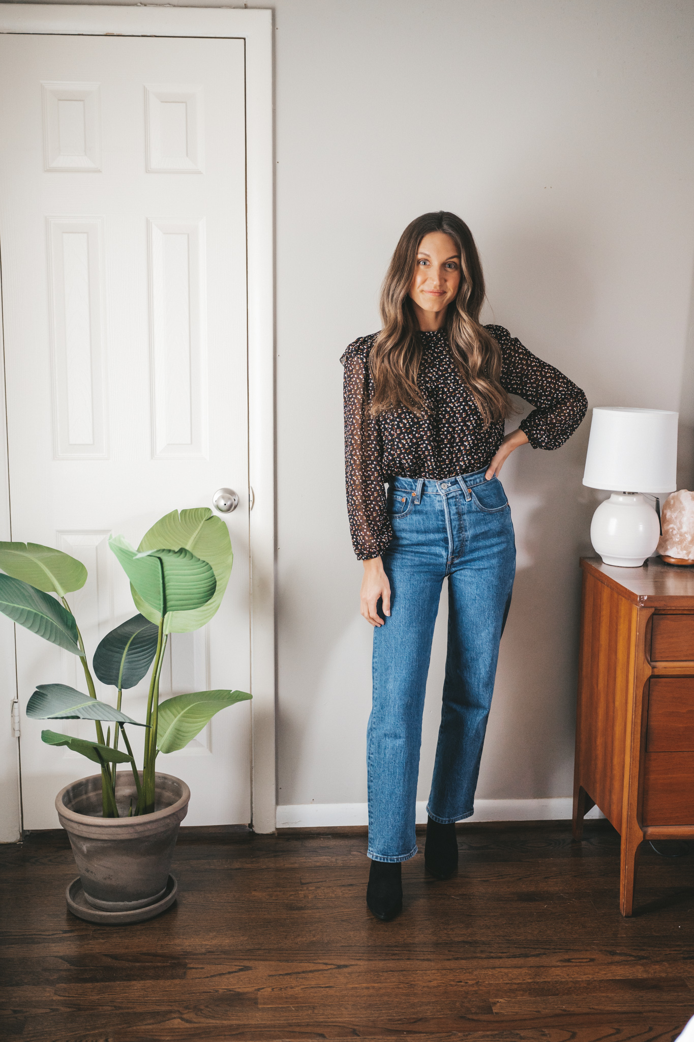 winter essential black ankle boots with straight leg denim, and a black floral blouse