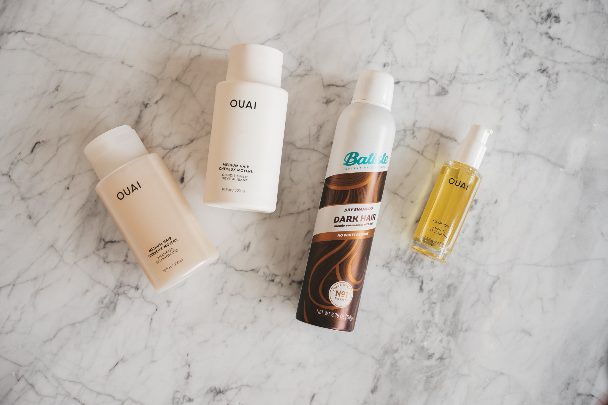 a white marble table with hair care products