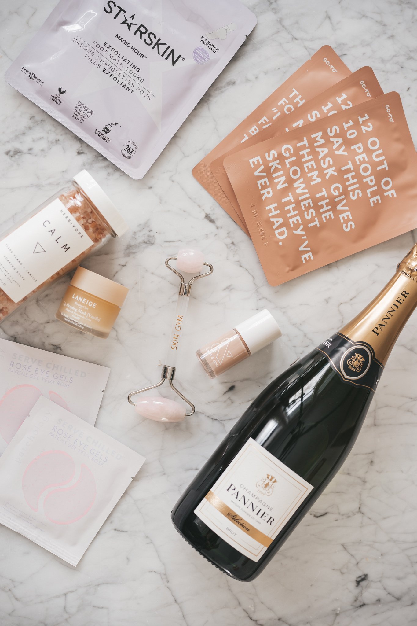 products for an at-home spa night laid out on a white marble table