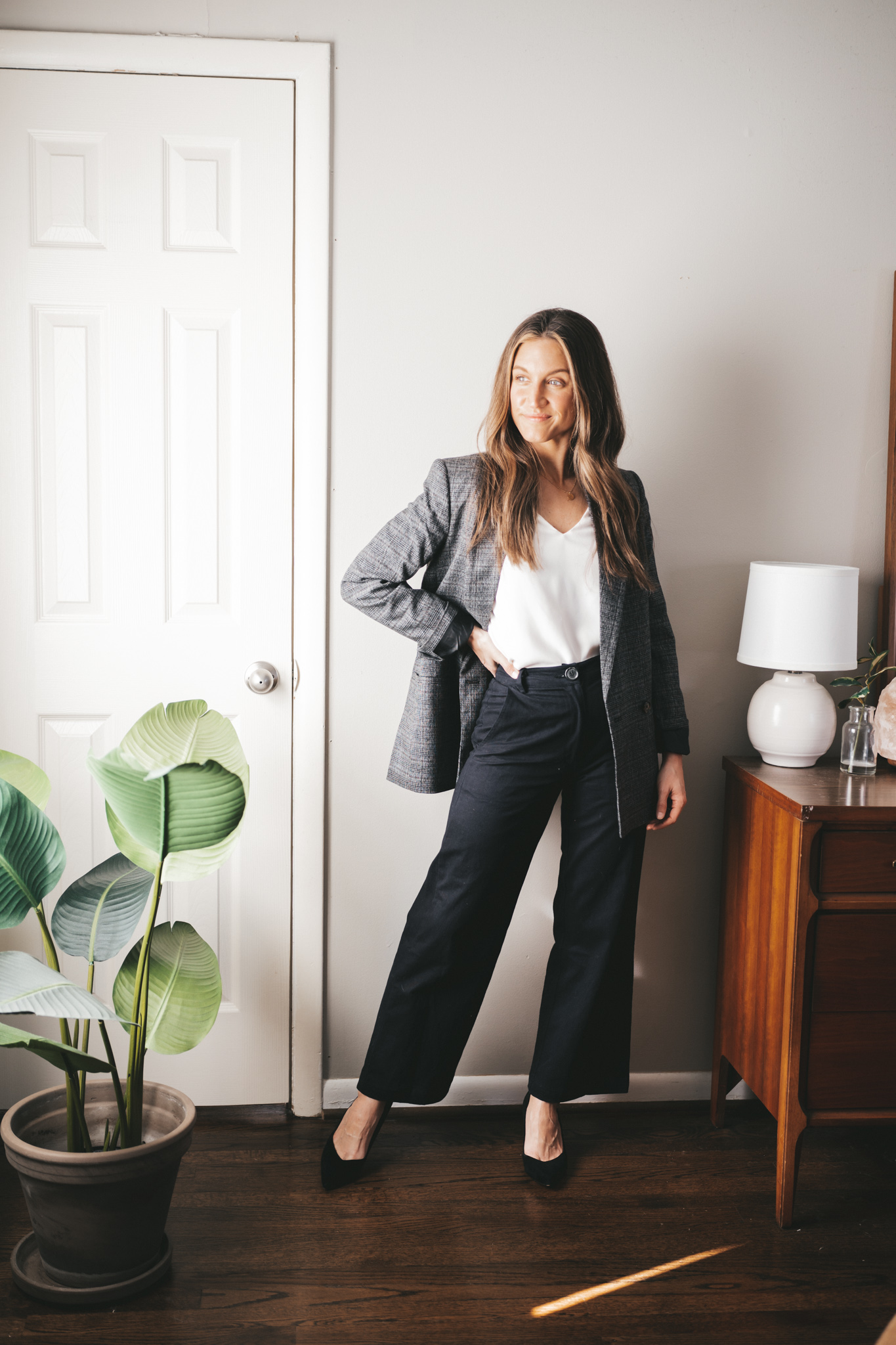 blazer outfit idea with an ivory blouse, black wide leg pants, a gray plaid blazer, and black pumps