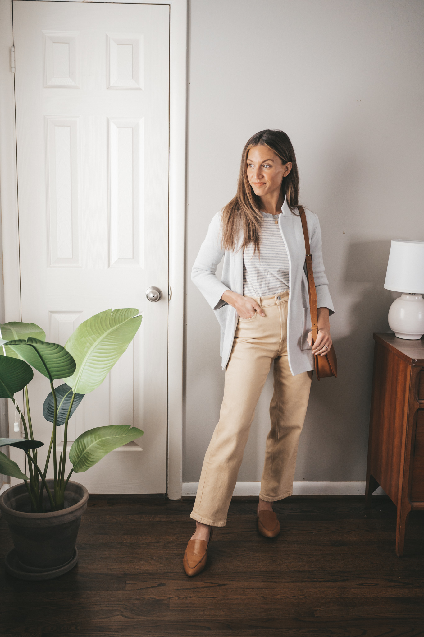 spring outfit idea with a striped top, gray sweater blazer, yellow denim, and cognac loafers