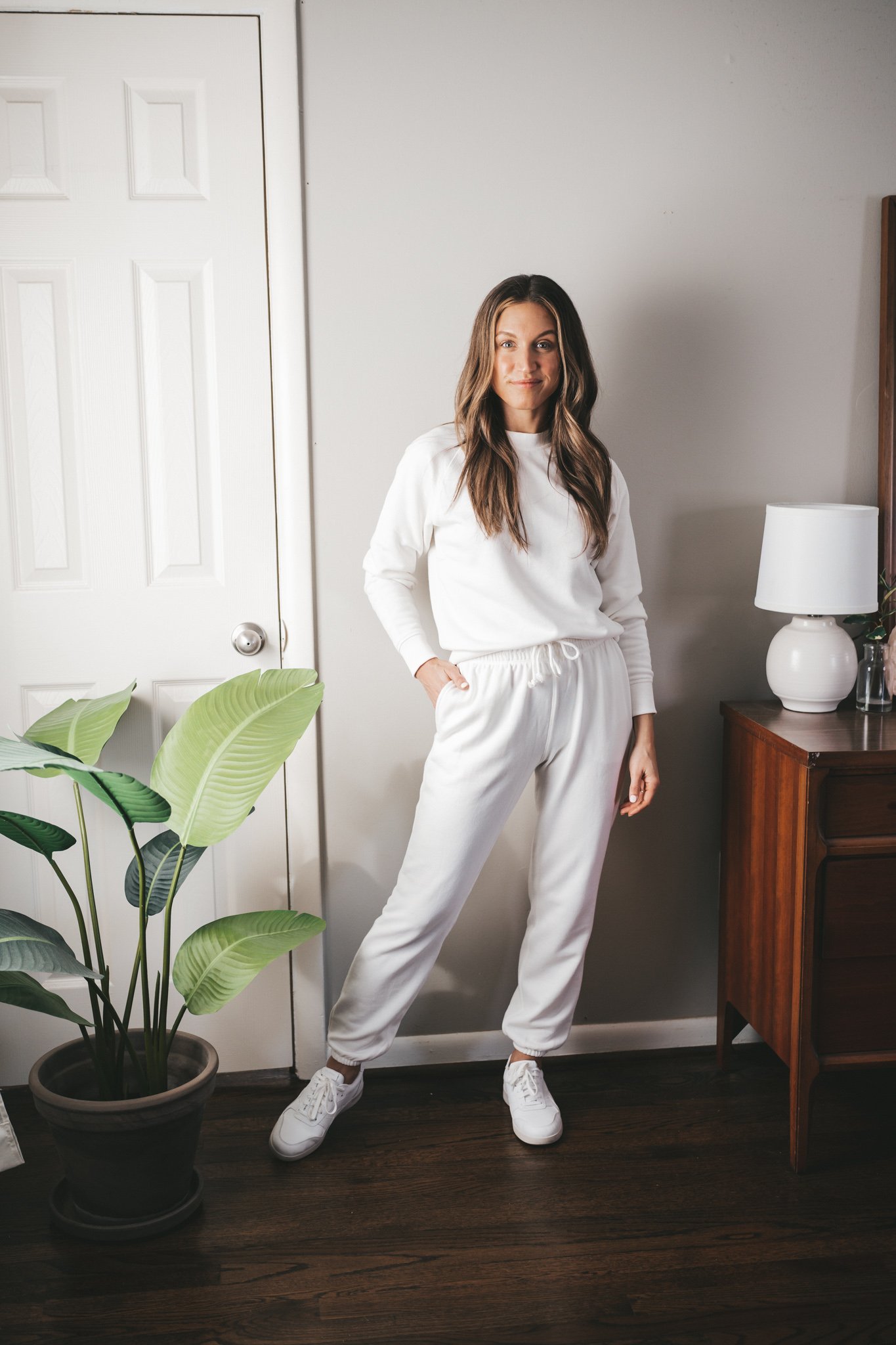 ashley wearing a white matching sweatsuit set 