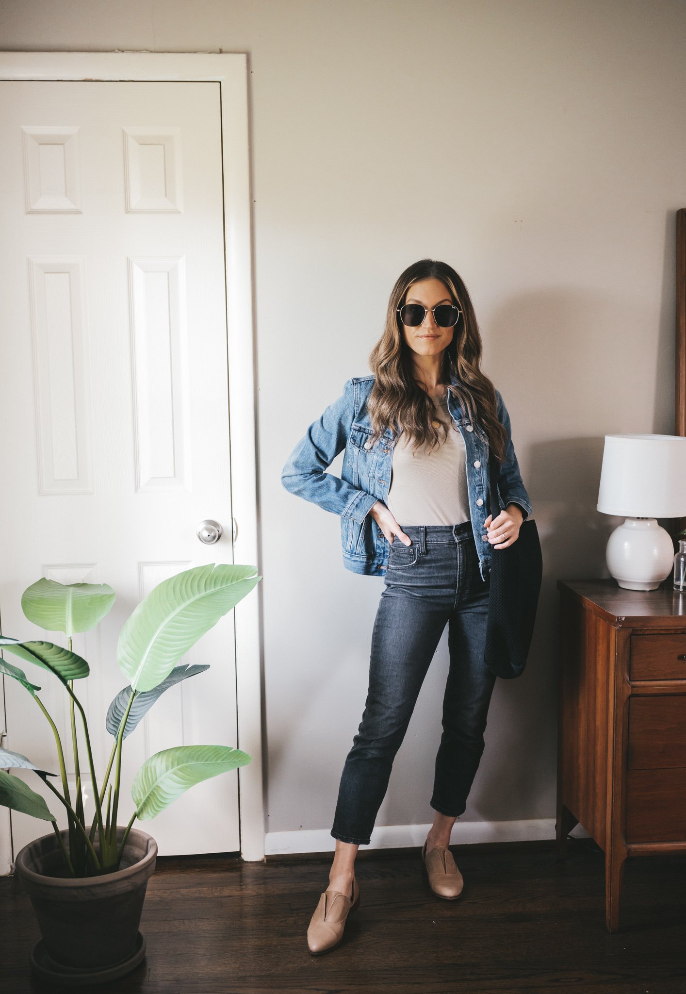 spring outfit with an olive green tank, denim jacket, black denim, and nude oxfords