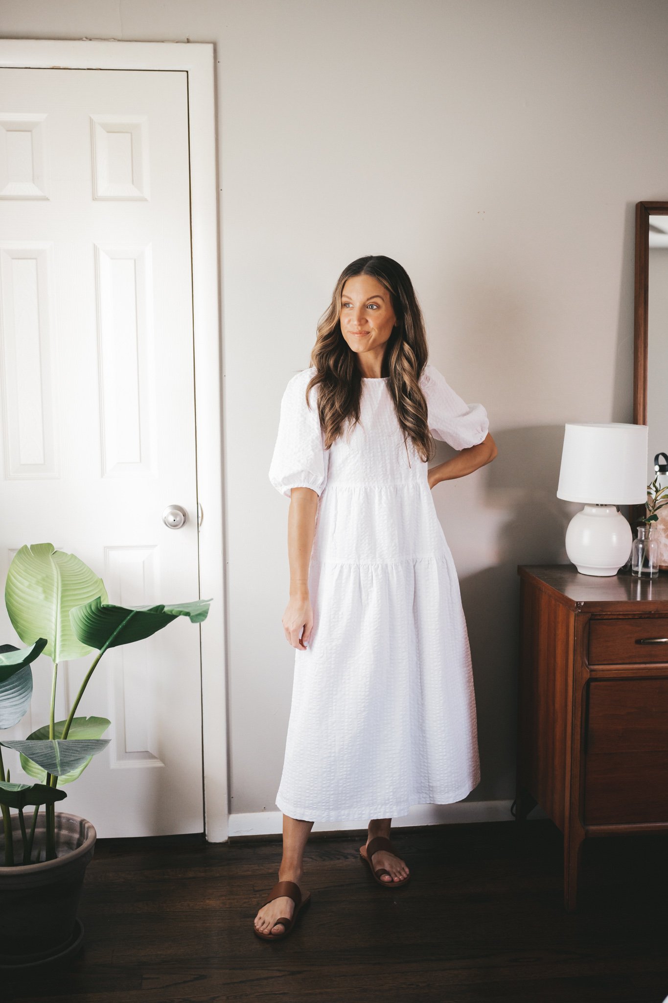 outfit for spring with a white puff sleeve midi dress and brown sandals