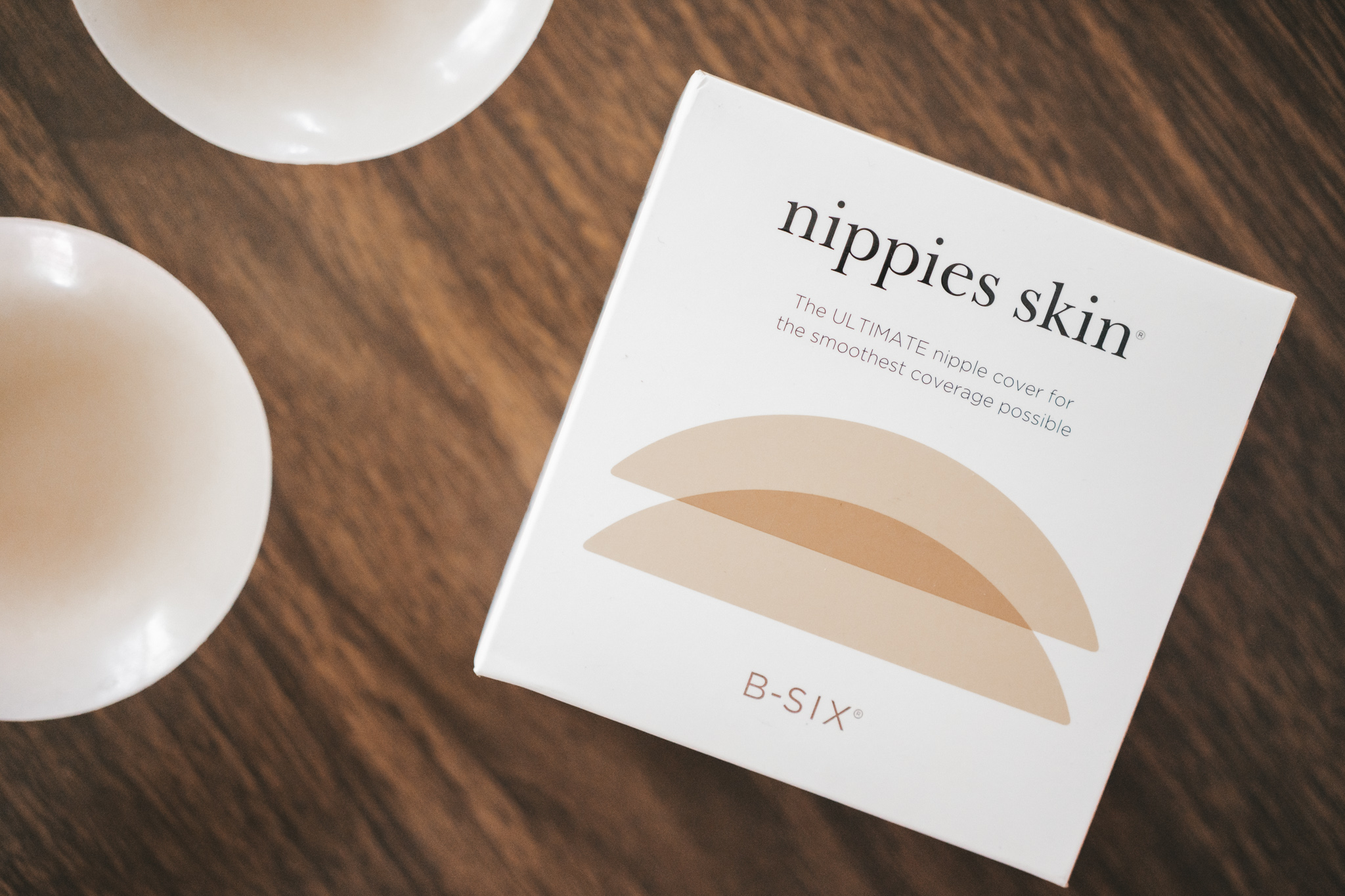 a package of Nippies Nipple Covers on a wood surface